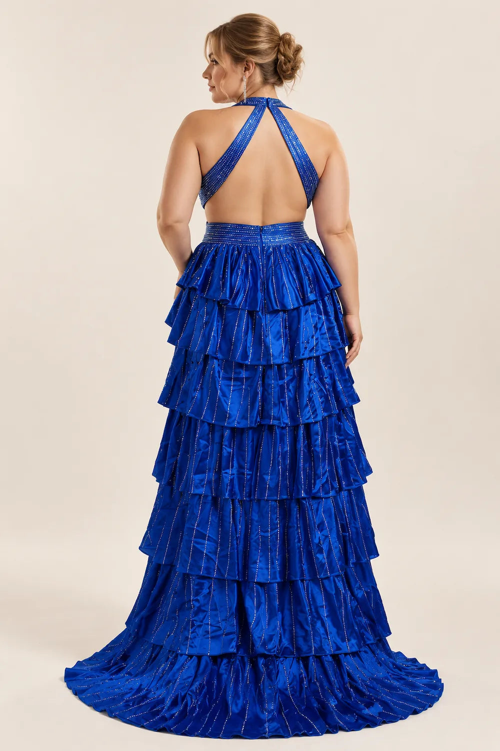 Royal blue halter tiered gown with ruffled skirt, strappy open back