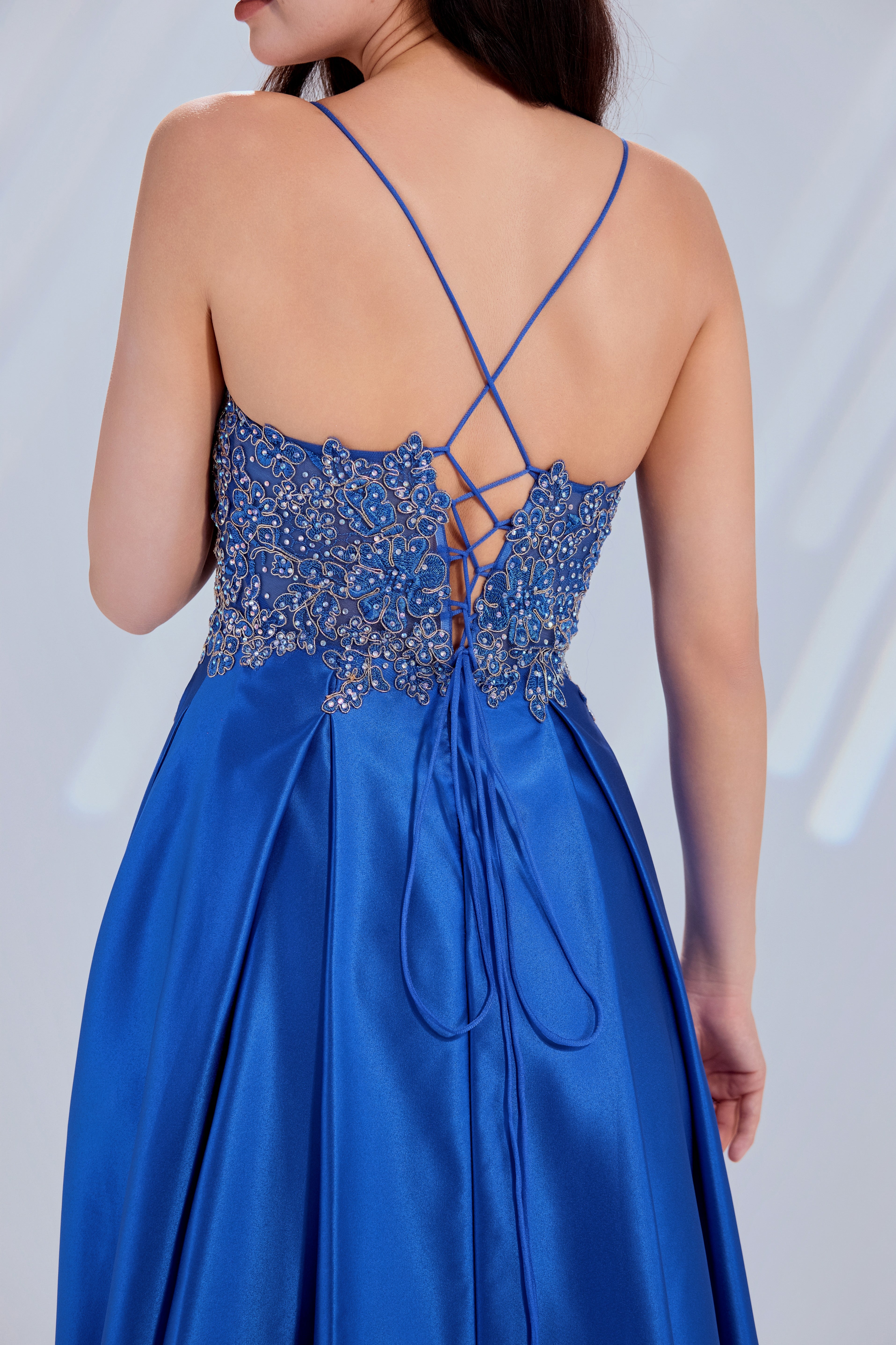 Blue satin prom dress back with crisscross lace straps over beaded bodice