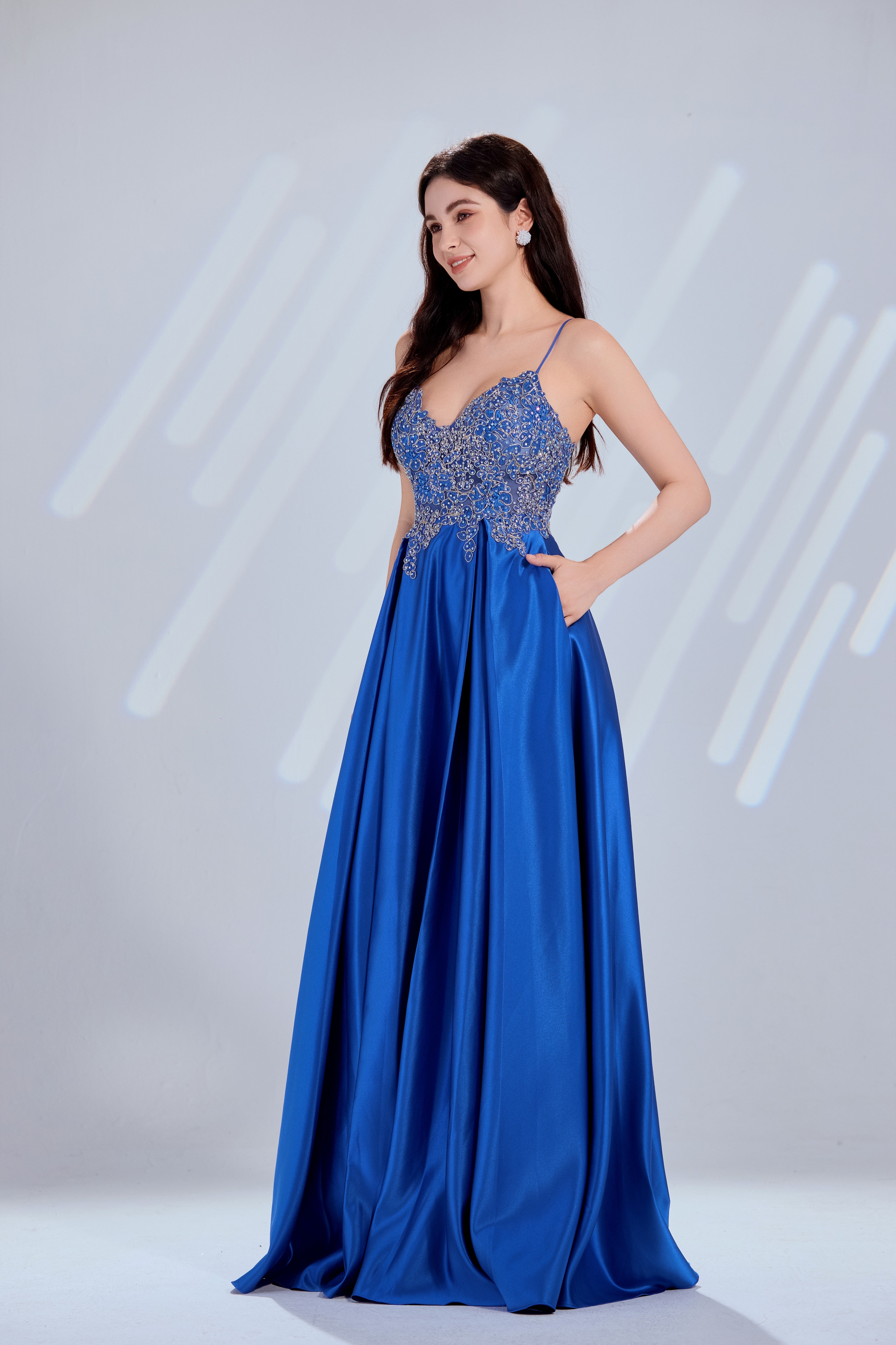 Blue satin prom dress with sparkling beaded bodice and flowing A-line skirt