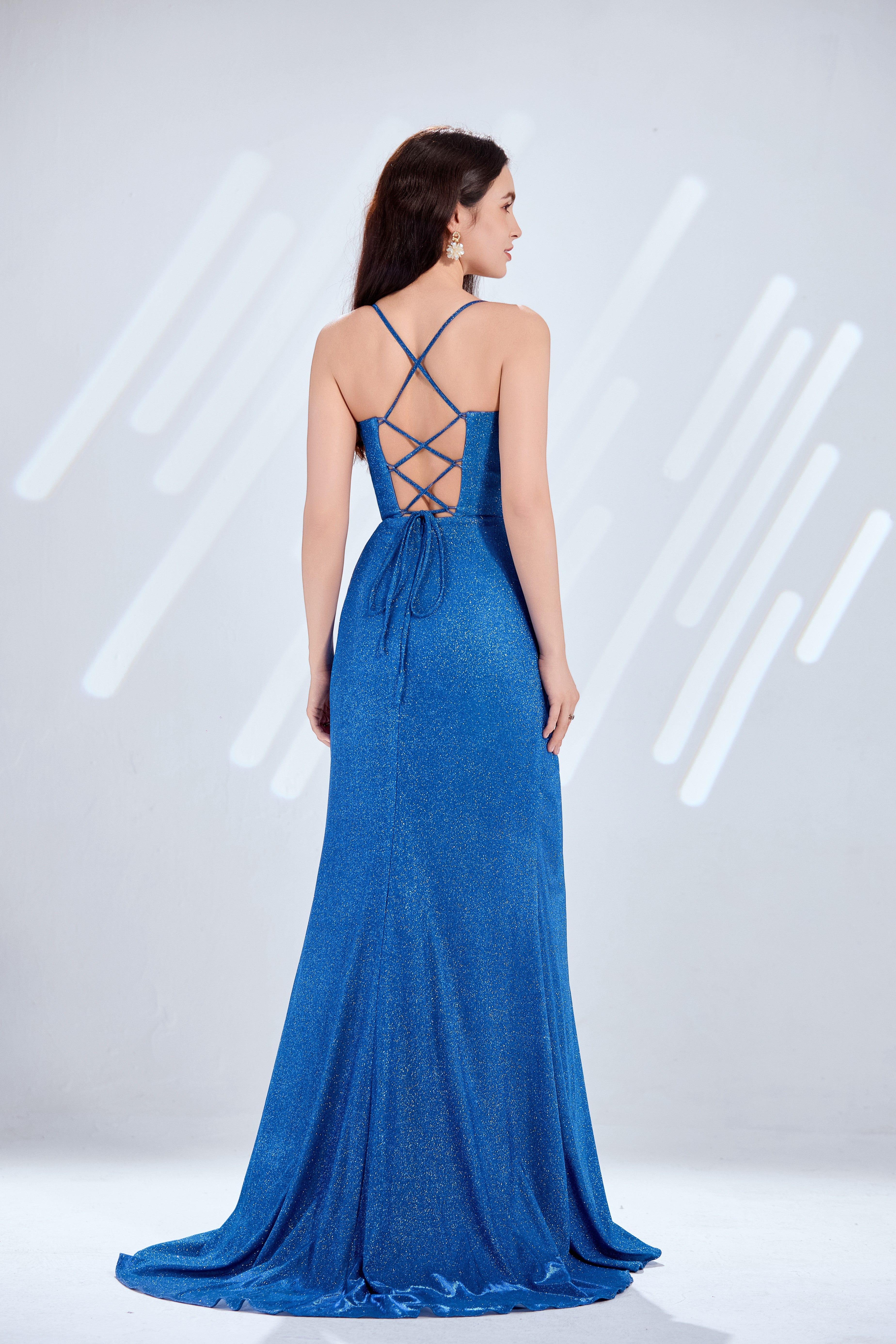Blue glitter satin corset gown with crisscross open-back straps and draped skirt