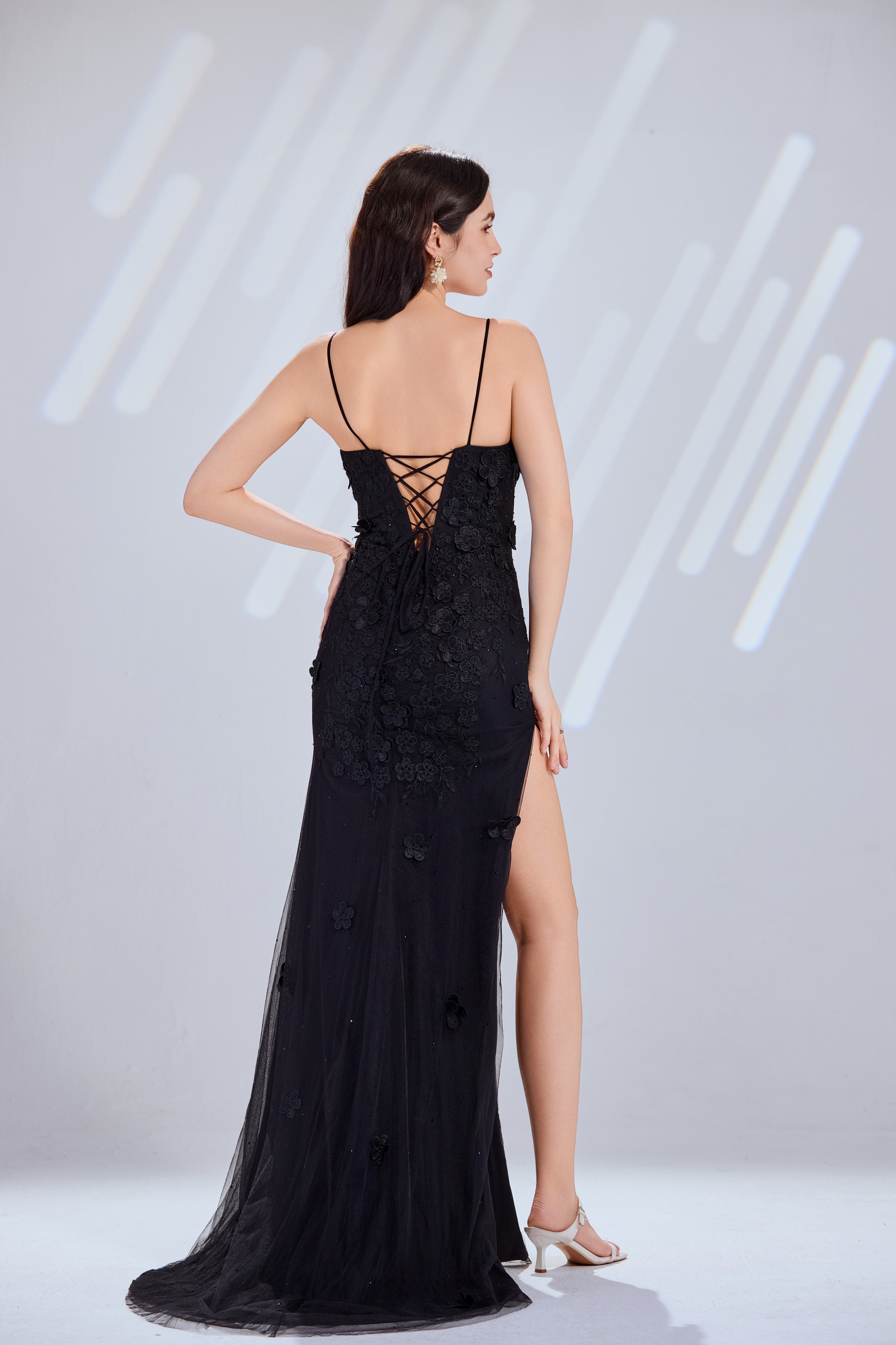 Black lace applique tulle mermaid prom dress from back view with lace-up detail