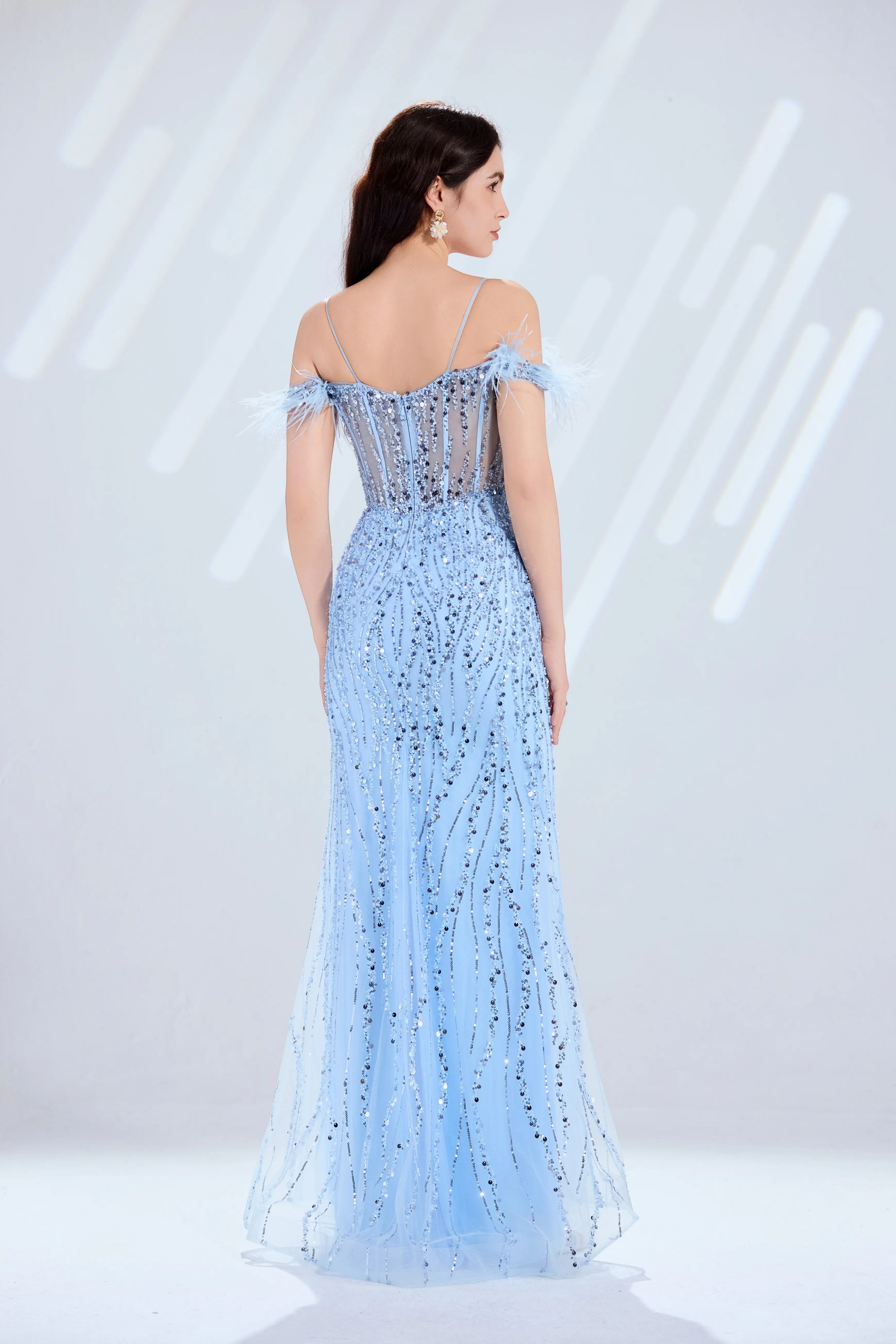 Sky blue sequin prom dress with open-back spaghetti straps, feather detail, and slit