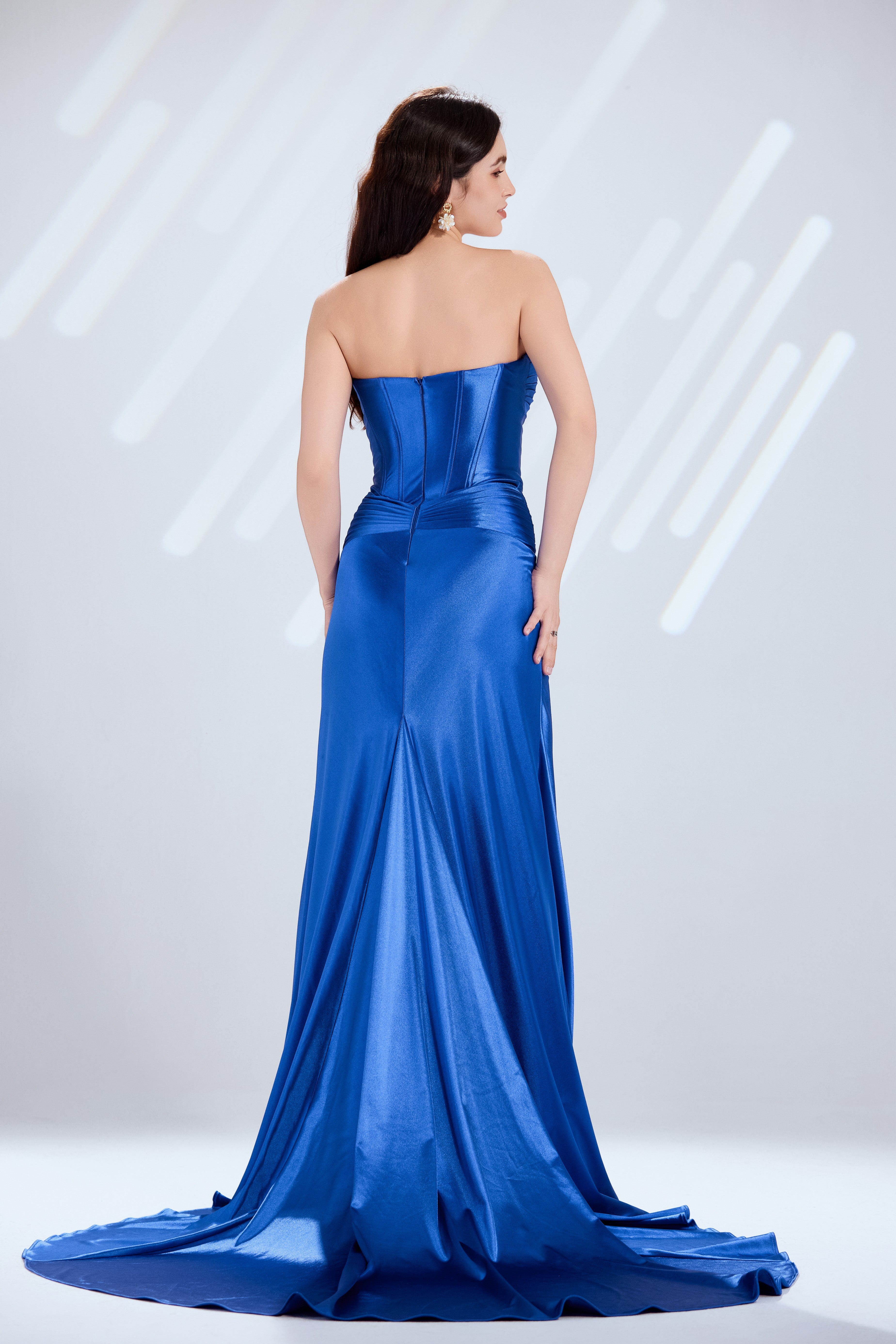 Royal blue strapless satin mermaid gown with corset back detailing and flowing skirt