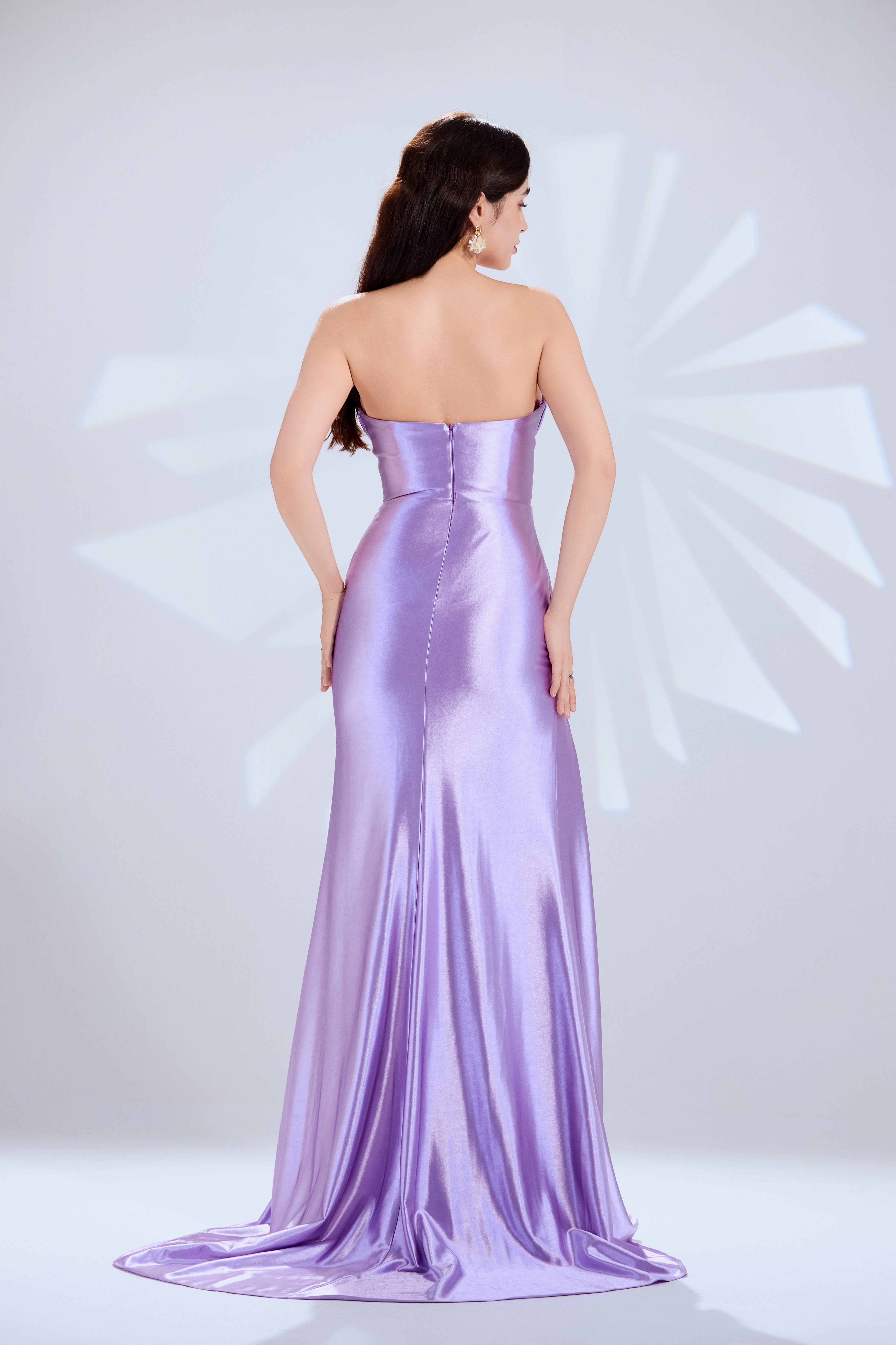 strapless satin dress with a draped bodice and high slit.