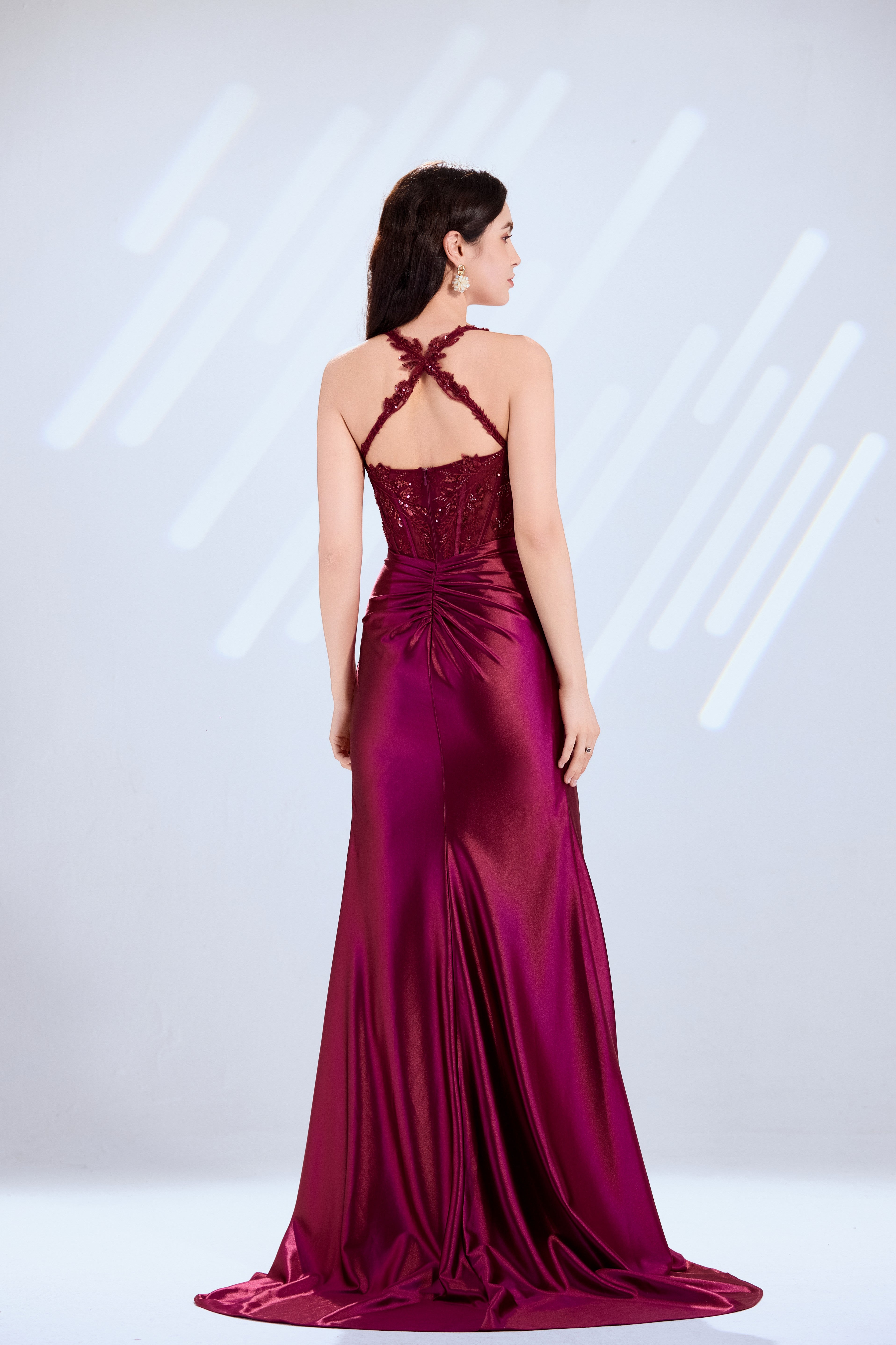 Wine mermaid gown back view: crisscross lace straps and ruched satin skirt