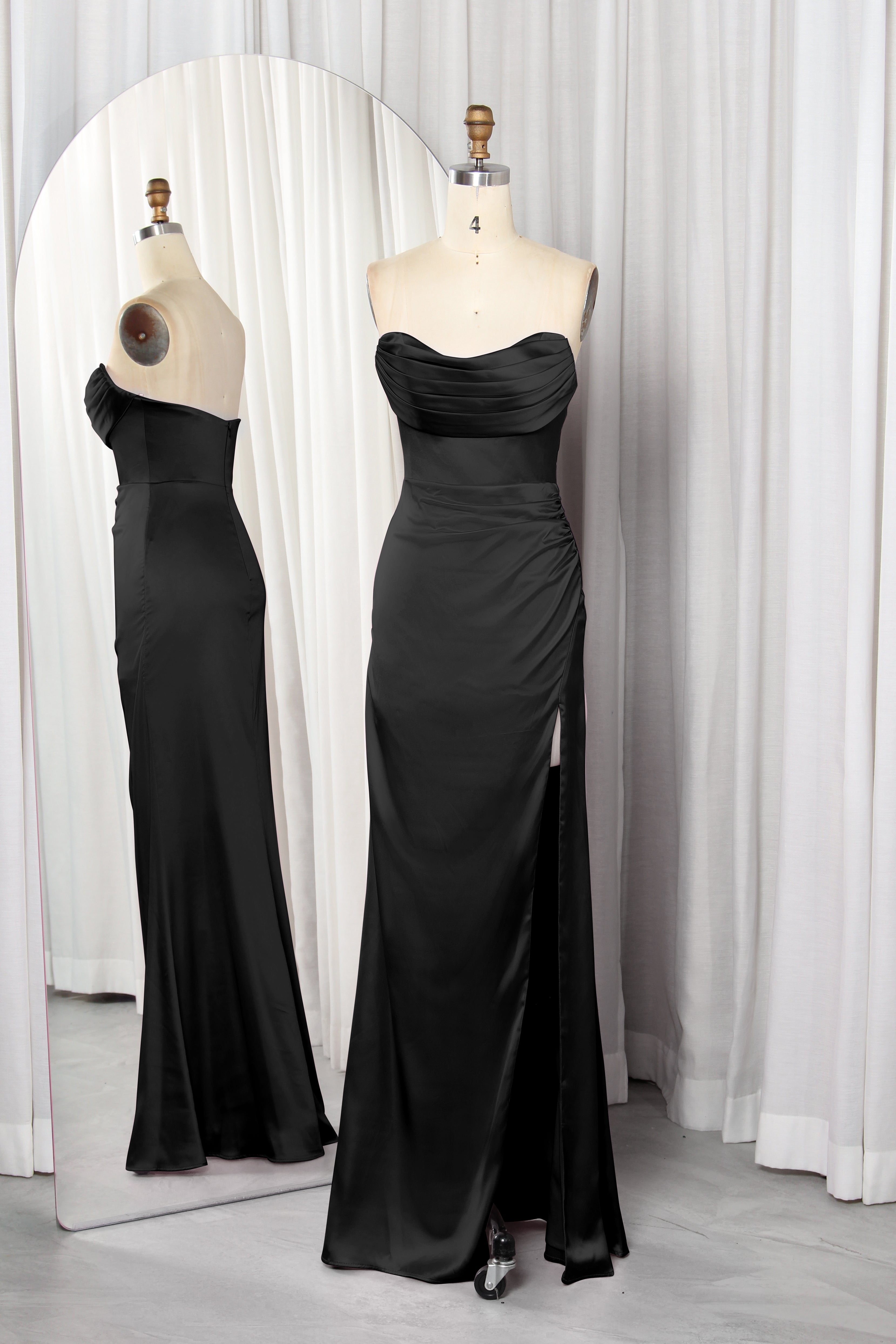 Front and back view of a vibrant red strapless satin evening gown with a ruched sweetheart neckline and high leg slit on a mannequin.