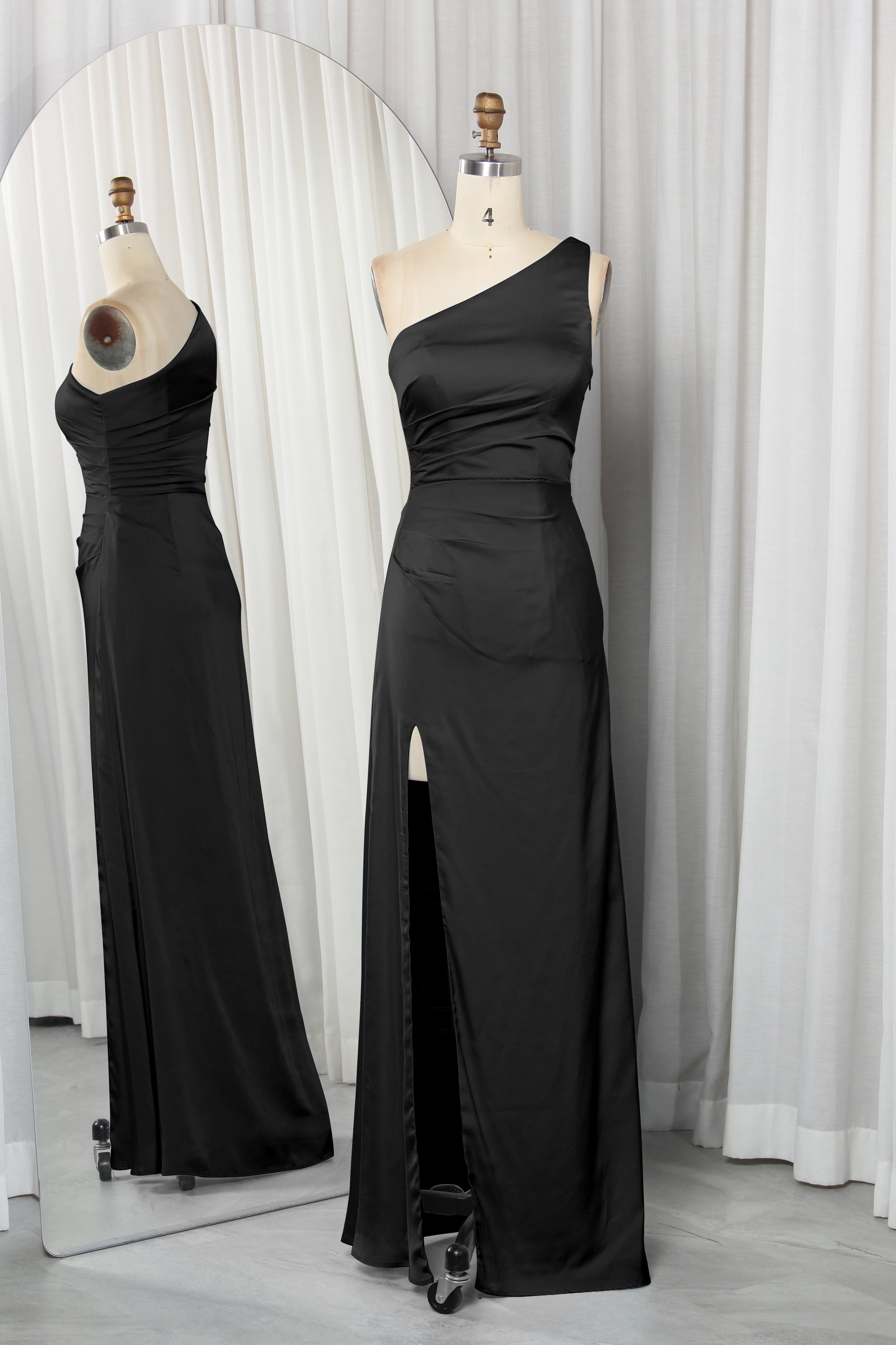 one-shoulder dress with a high slit displayed on a mannequin.