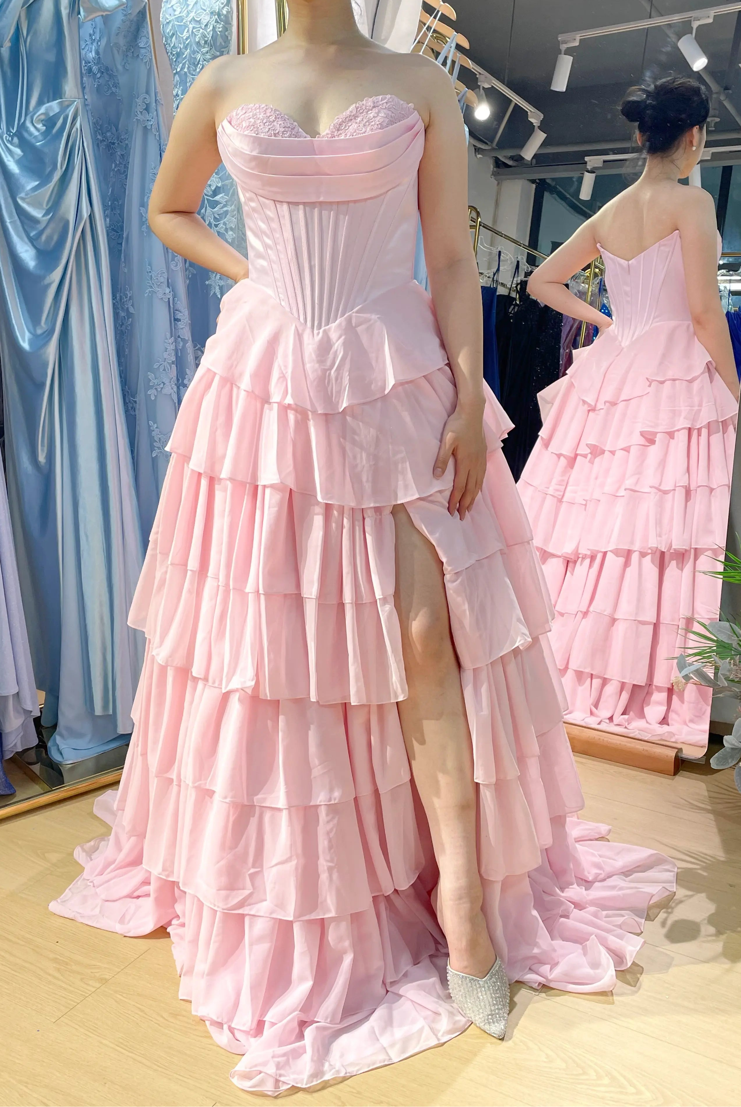 Structured corset tiered ruffle ball gown in light pink with sweetheart lace neckline.