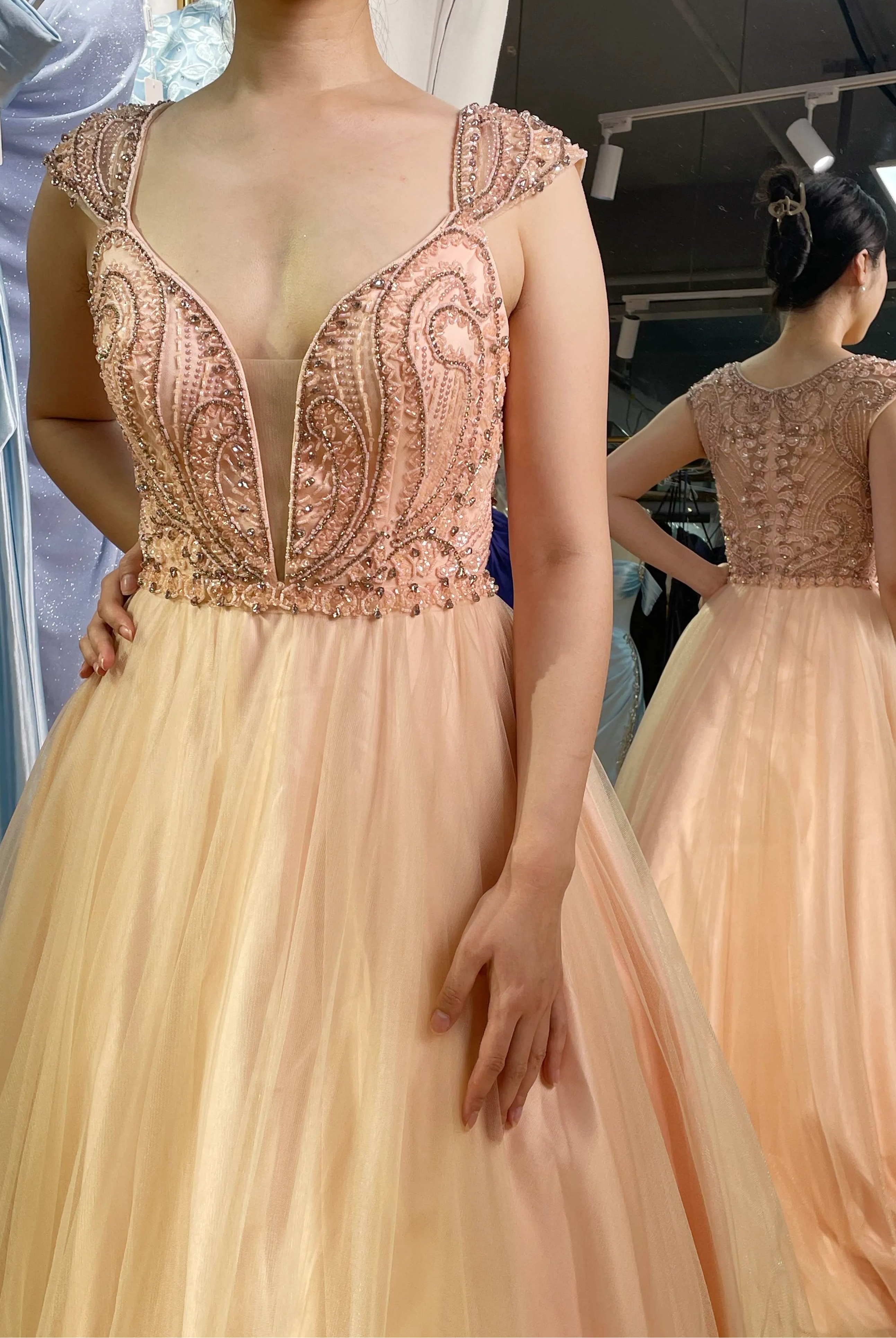 A-line prom dress with rose-beaded V-neck bodice and peach tulle skirt, sleeveless