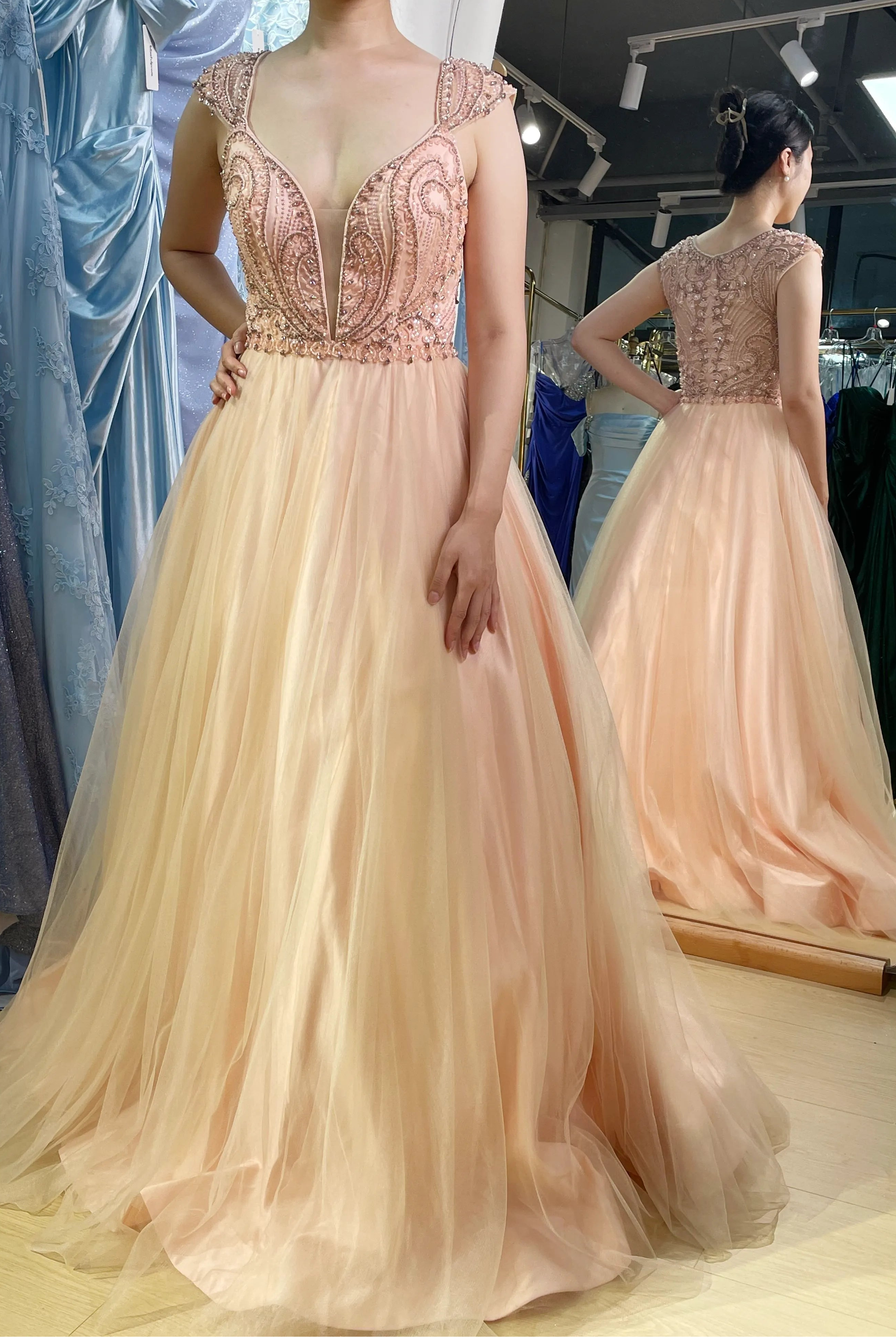 A-line prom dress with rose-beaded bodice, deep V neckline and peach tulle skirt