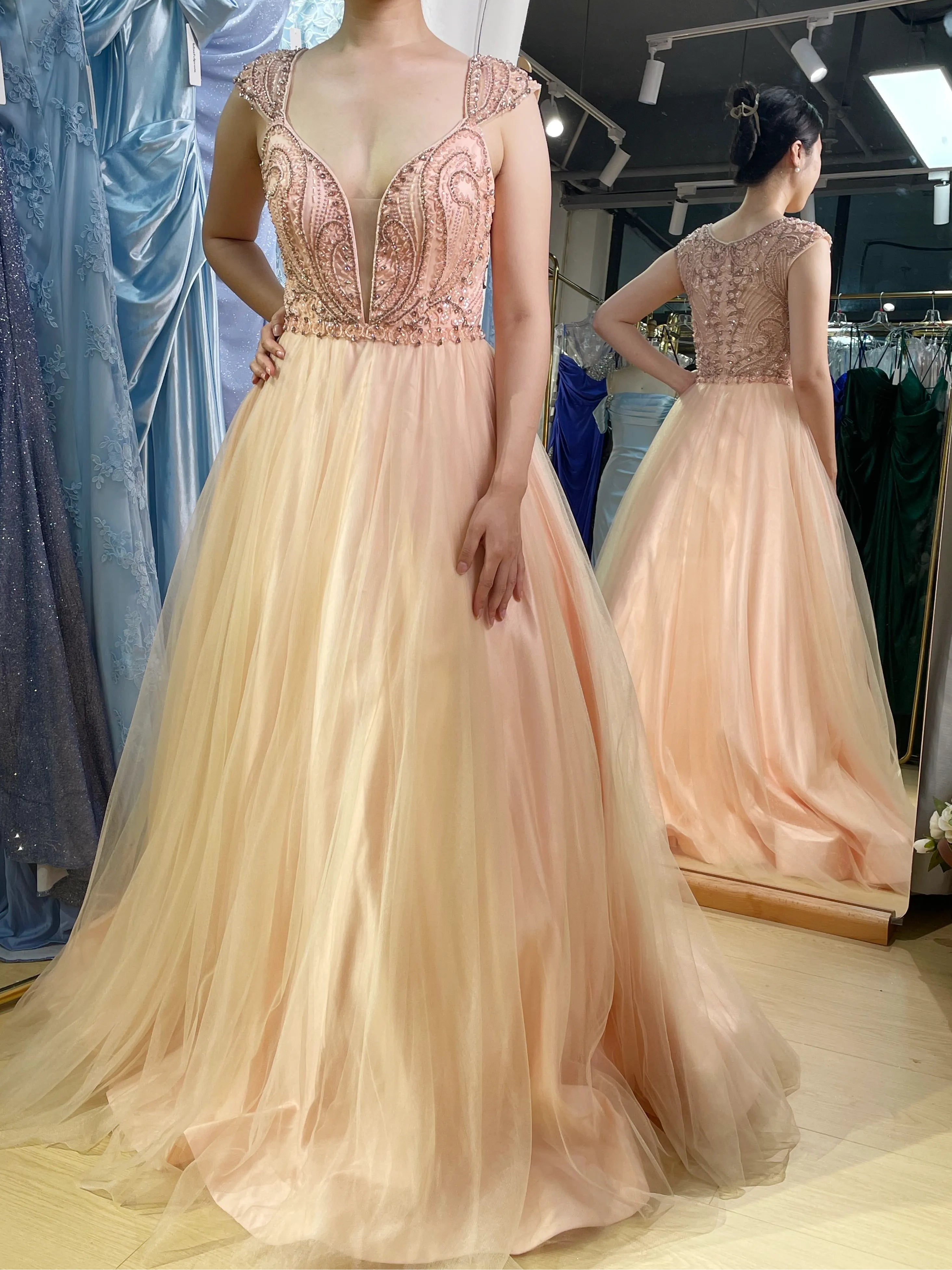Champagne A-line prom dress with ornate beaded bodice and flowing tulle skirt