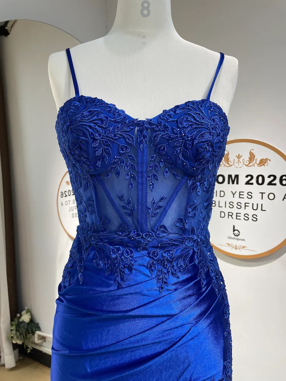 Royal blue lace corset-style evening dress with spaghetti straps and ruched skirt