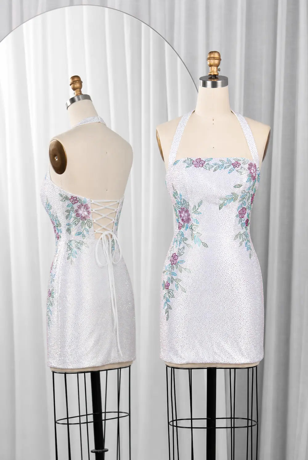 White sequin mini dress with floral rhinestones, spaghetti straps, lace-back