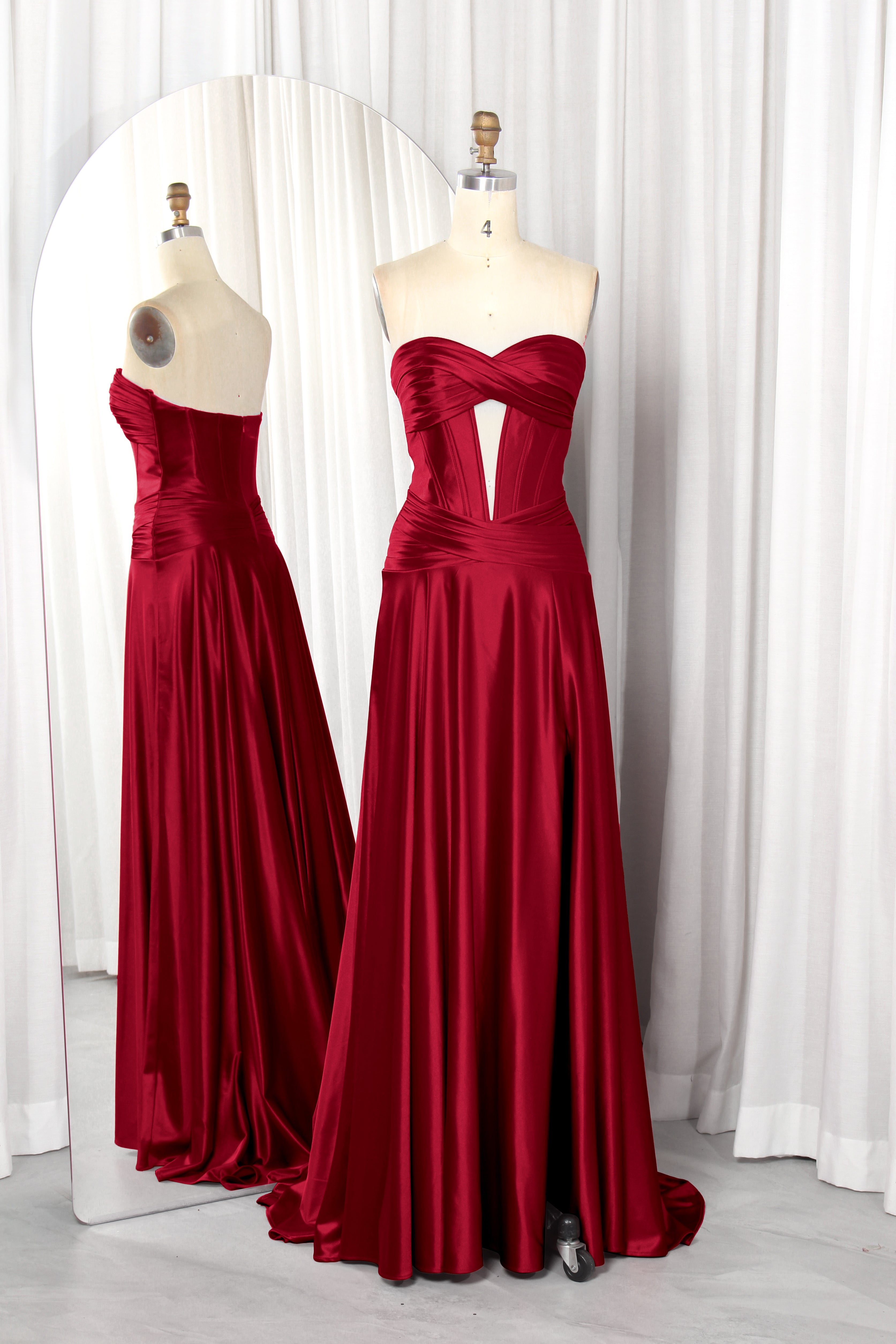 strapless satin prom dress with a front cutout and high slit.