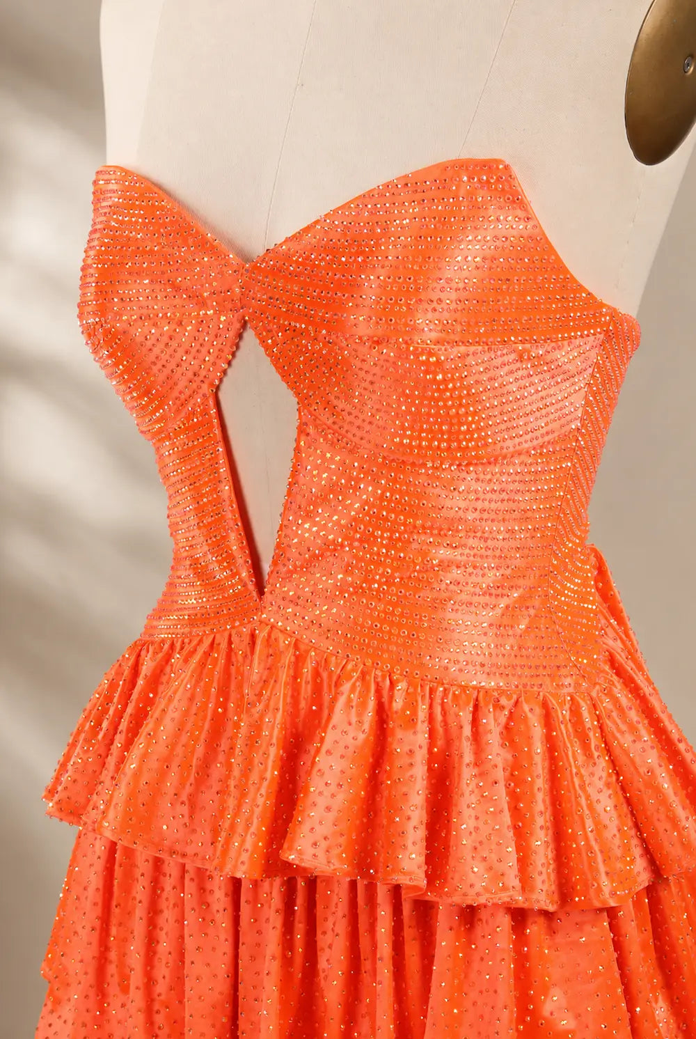 Orange sweetheart mini sequin dress with layered ruffle skirt, corset bodice