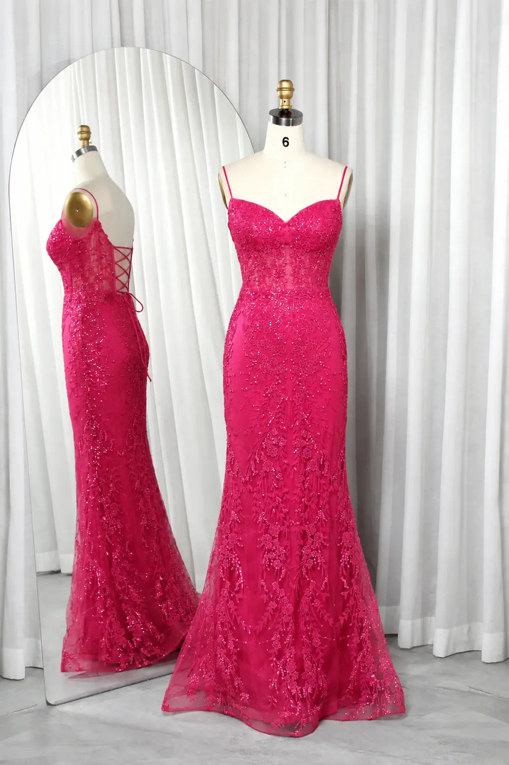 Hot pink mermaid corset prom dress with lace texture and thin straps