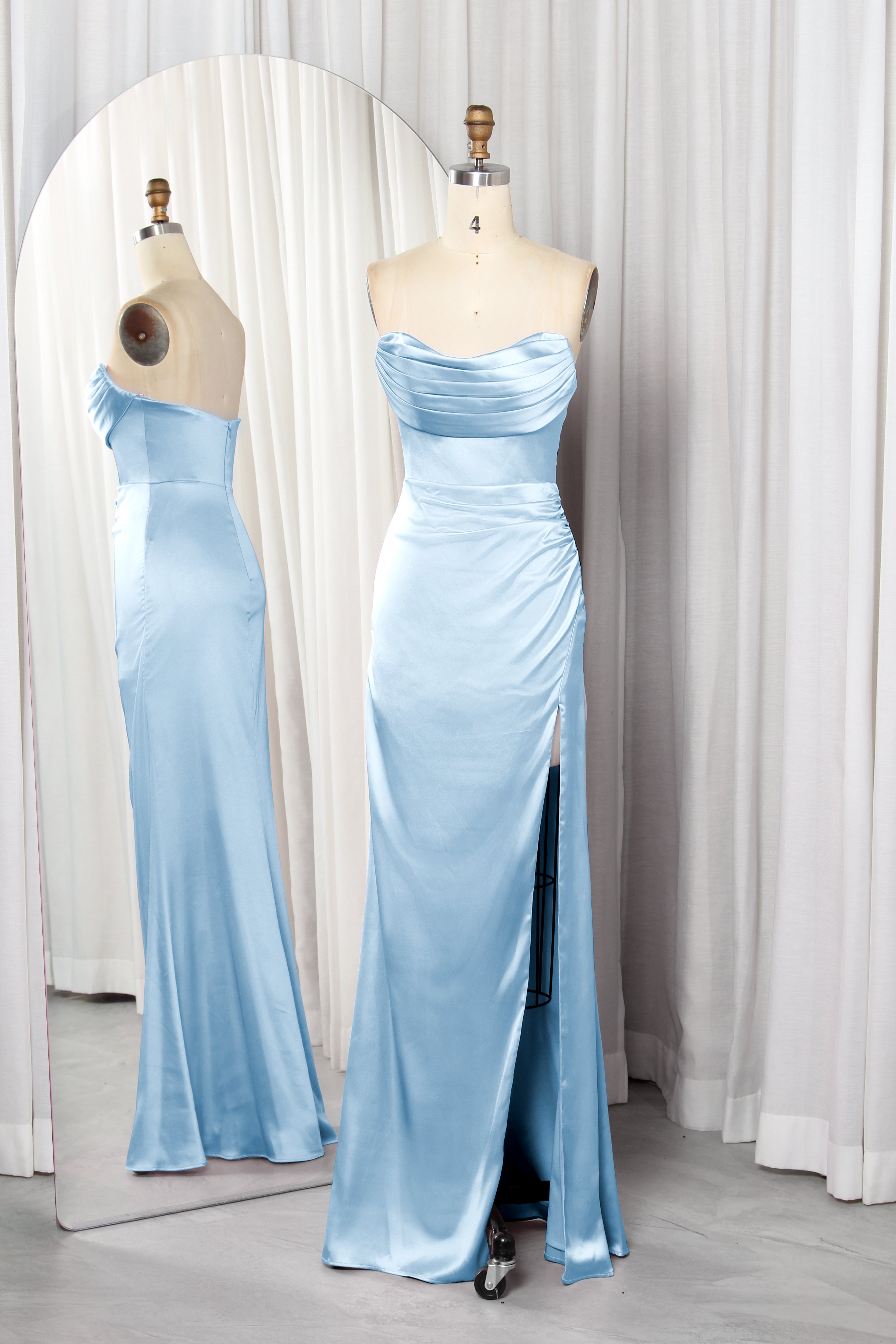 Front and back view of a vibrant red strapless satin evening gown with a ruched sweetheart neckline and high leg slit on a mannequin.