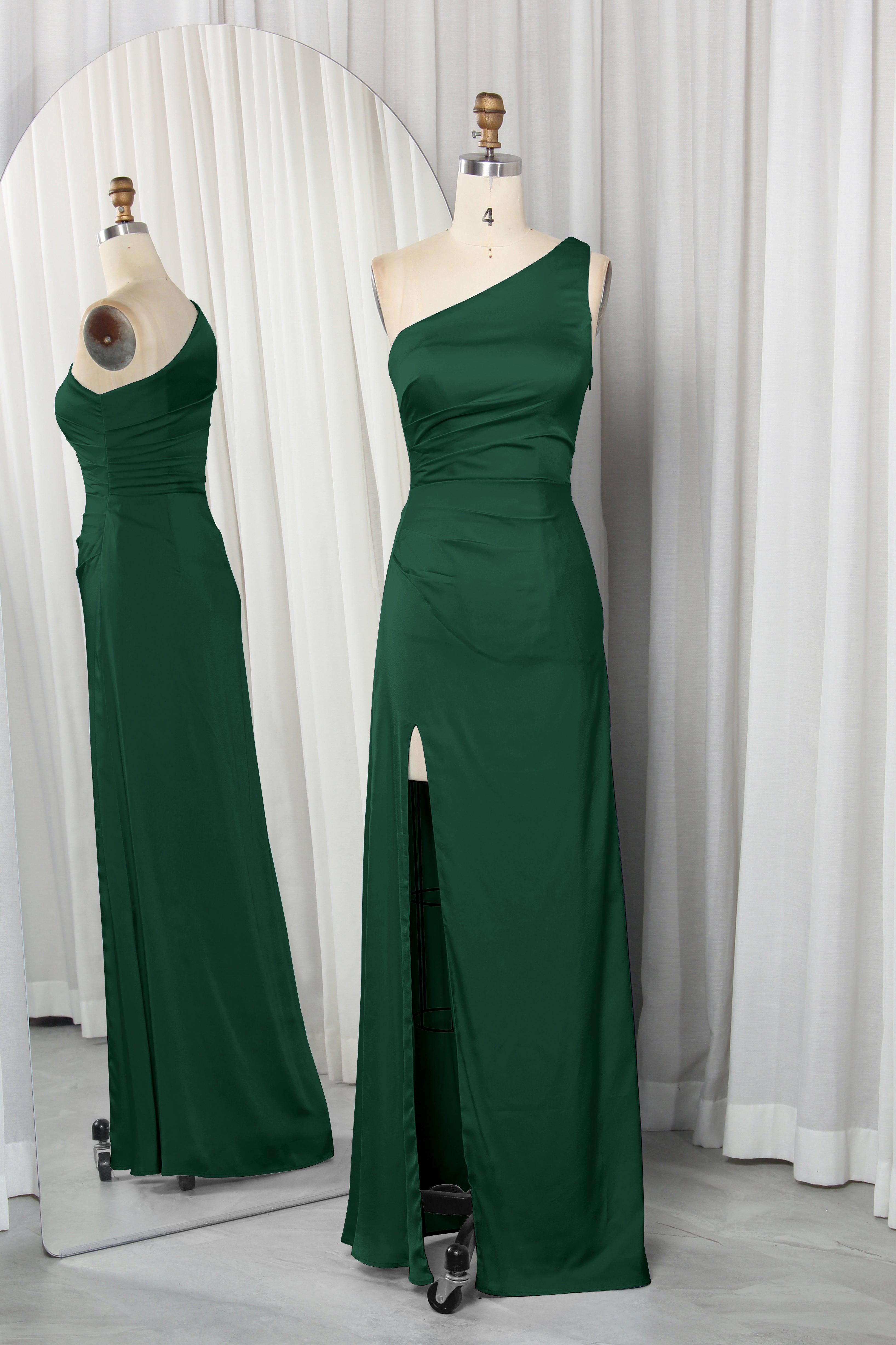 one-shoulder dress with a high slit displayed on a mannequin.
