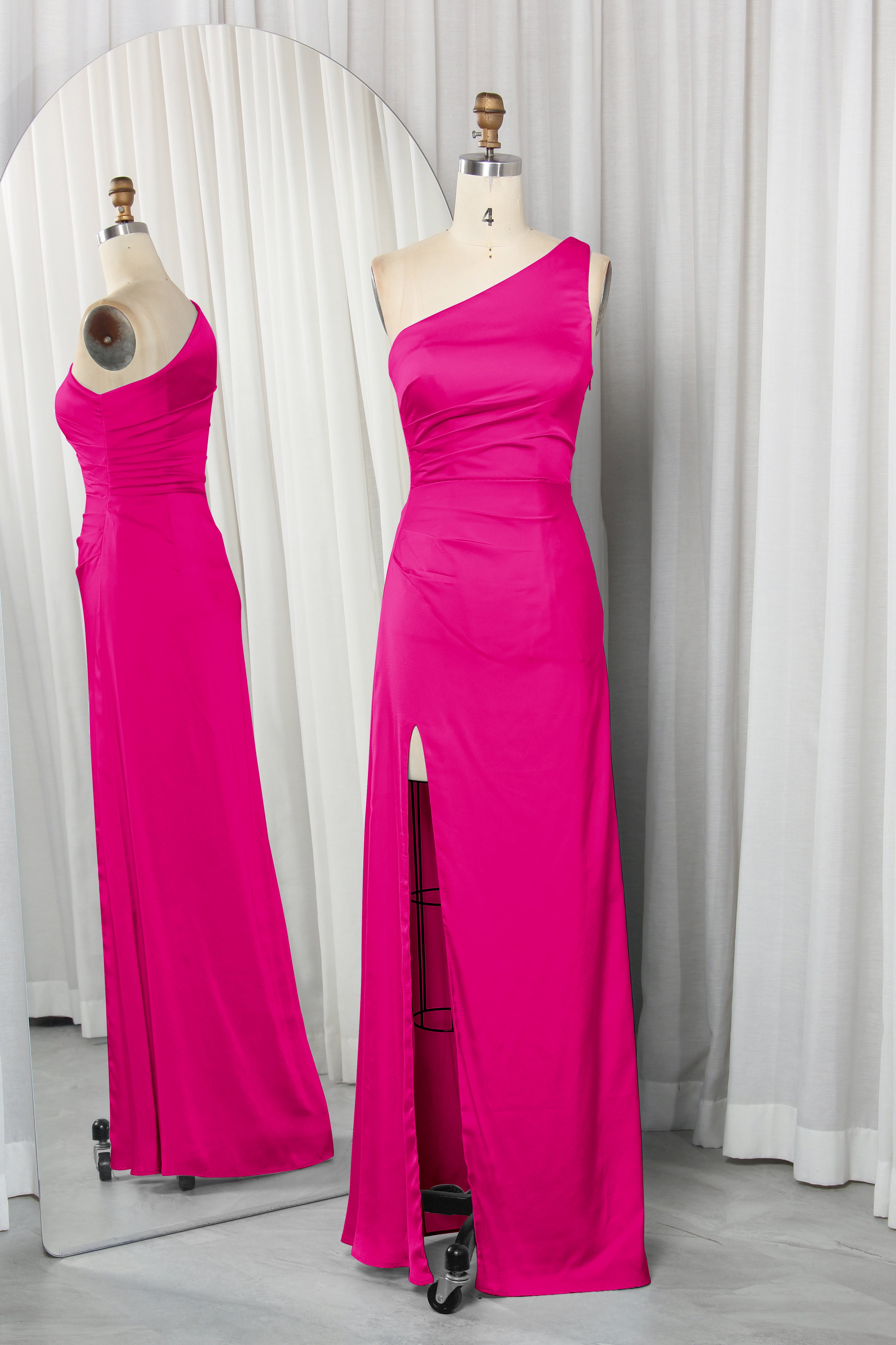 one-shoulder dress with a high slit displayed on a mannequin.