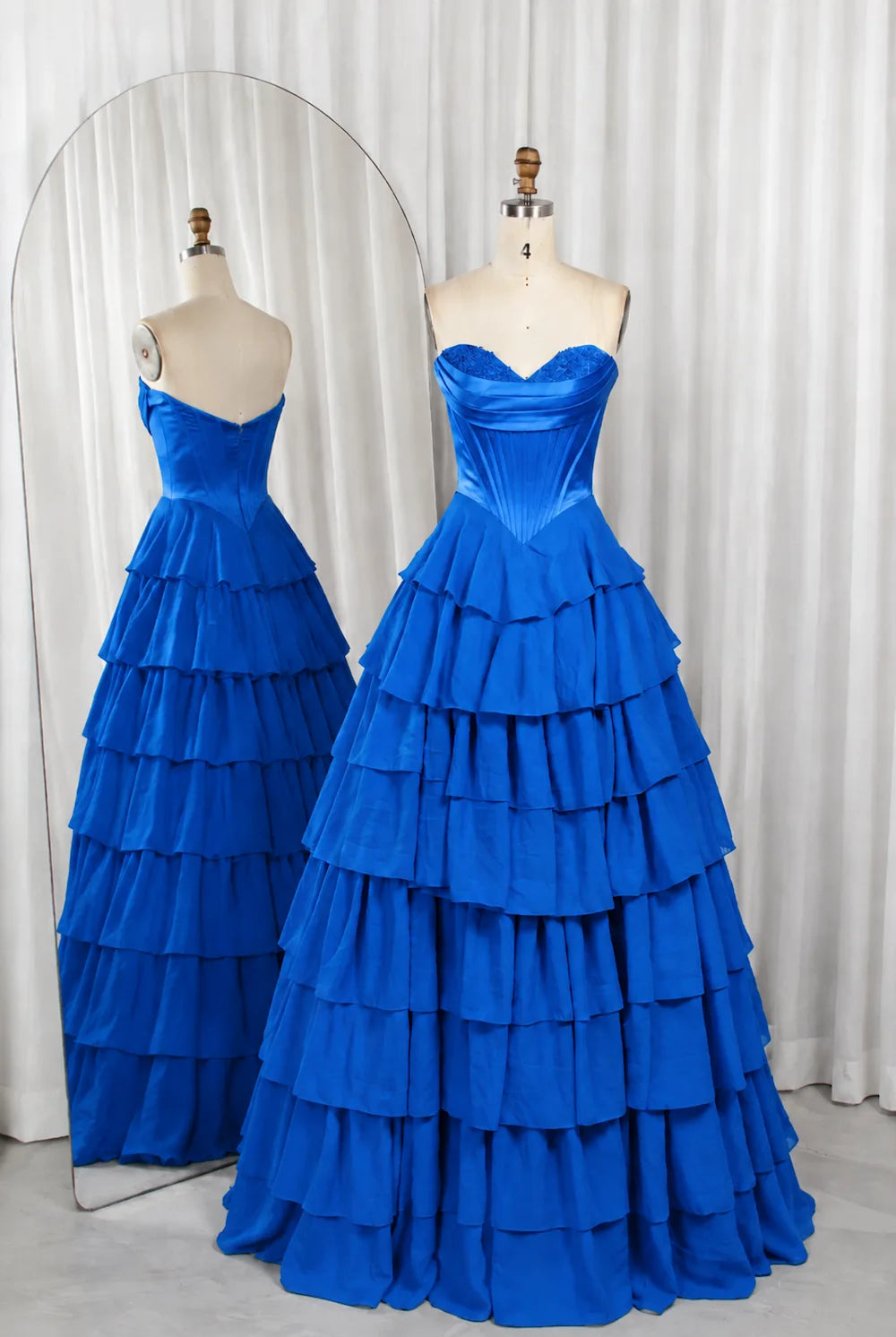 Royal-blue strapless corset-style bodice ball gown with tiered ruffle skirt.
