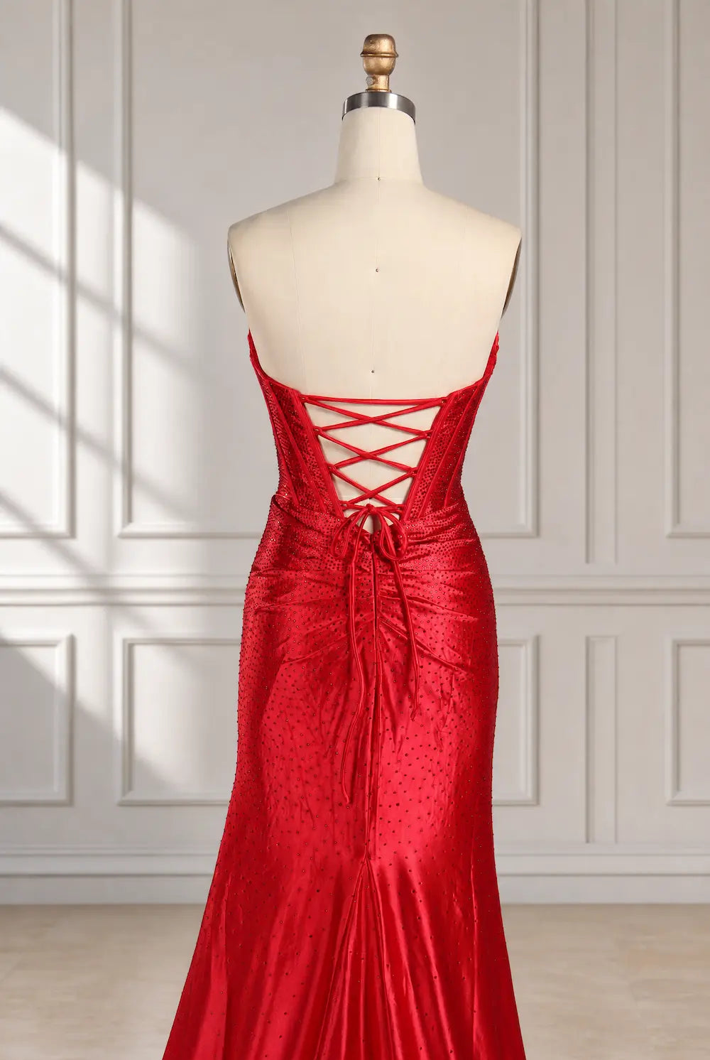 Red fitted evening dress with crisscross back lacing and high-sheen finish