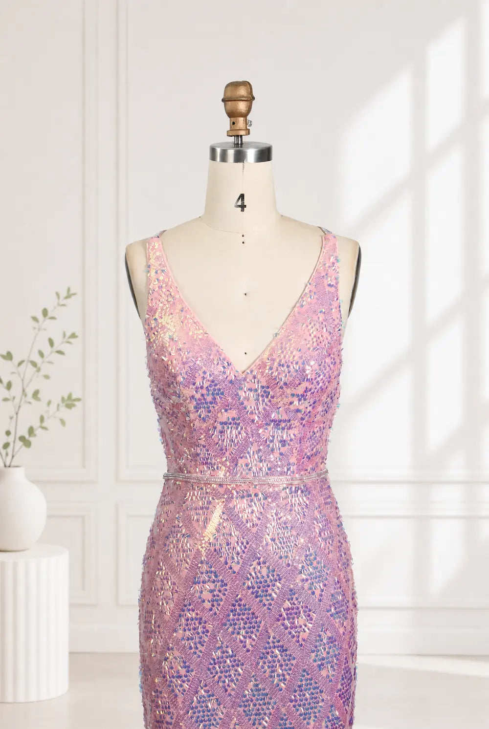 Iridescent pink sequin mermaid prom dress on mannequin with V-neck fitted bodice