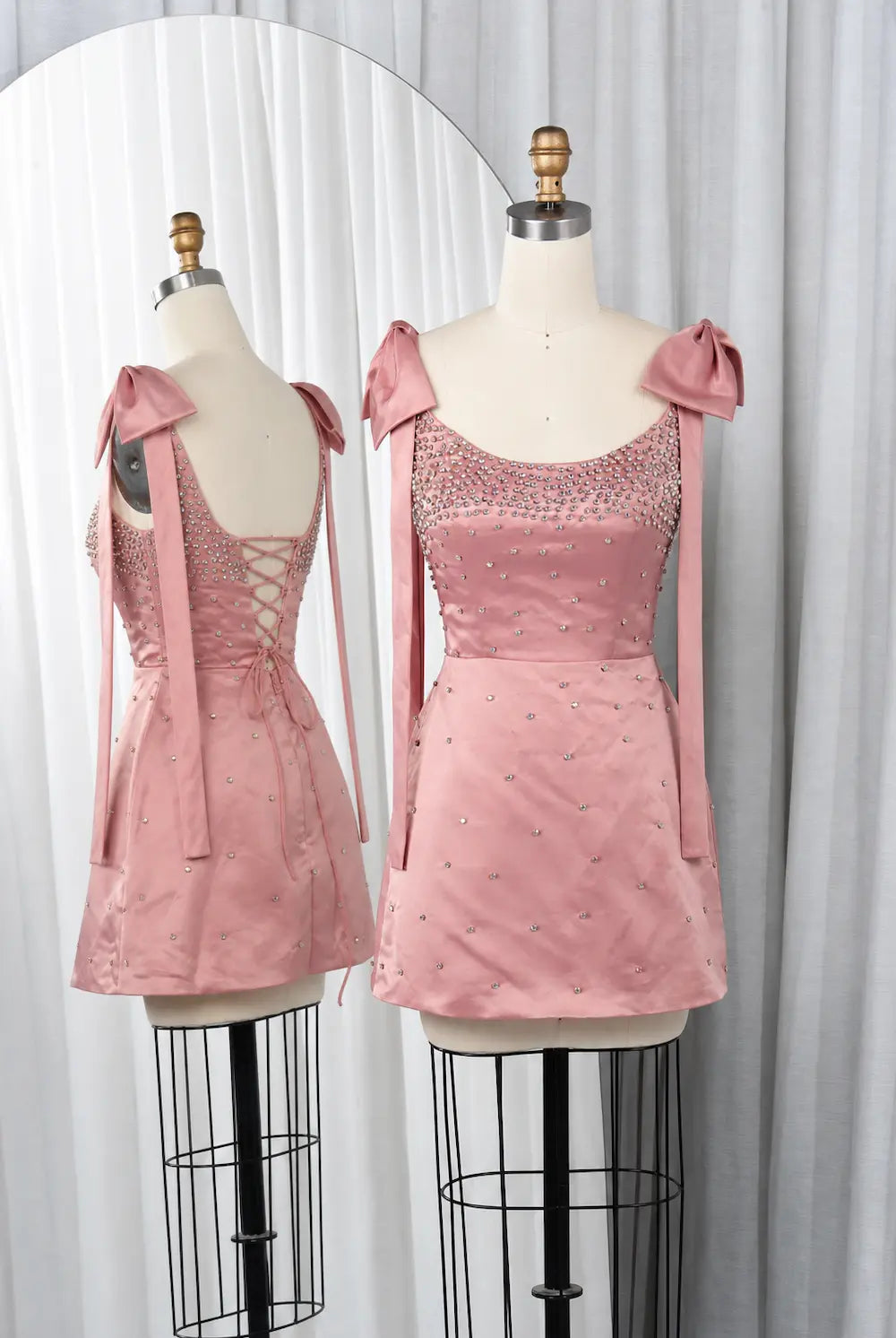 Pink sequin mini dress with sweetheart neckline and bow shoulder ties