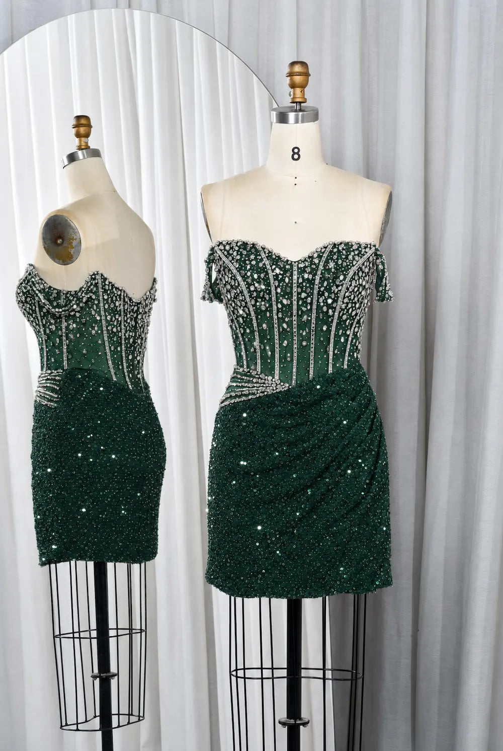 Emerald green sequin mini dress with off-shoulder beaded corset bodice and ruched skirt