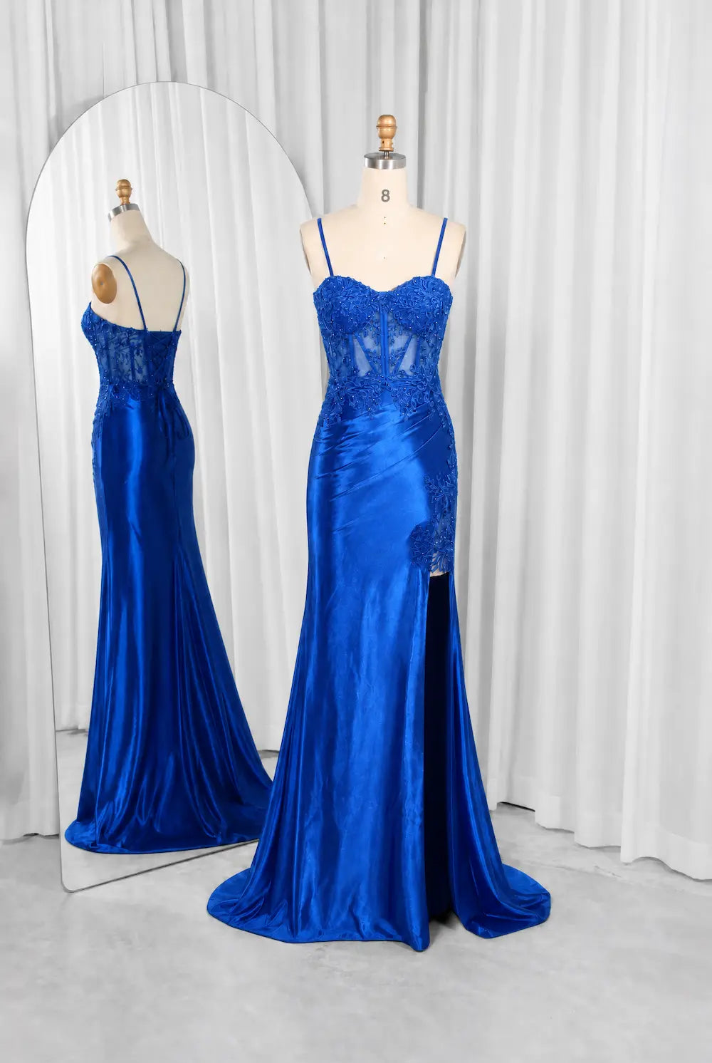 Royal blue evening gown on mannequin with lace corset bodice and thin straps