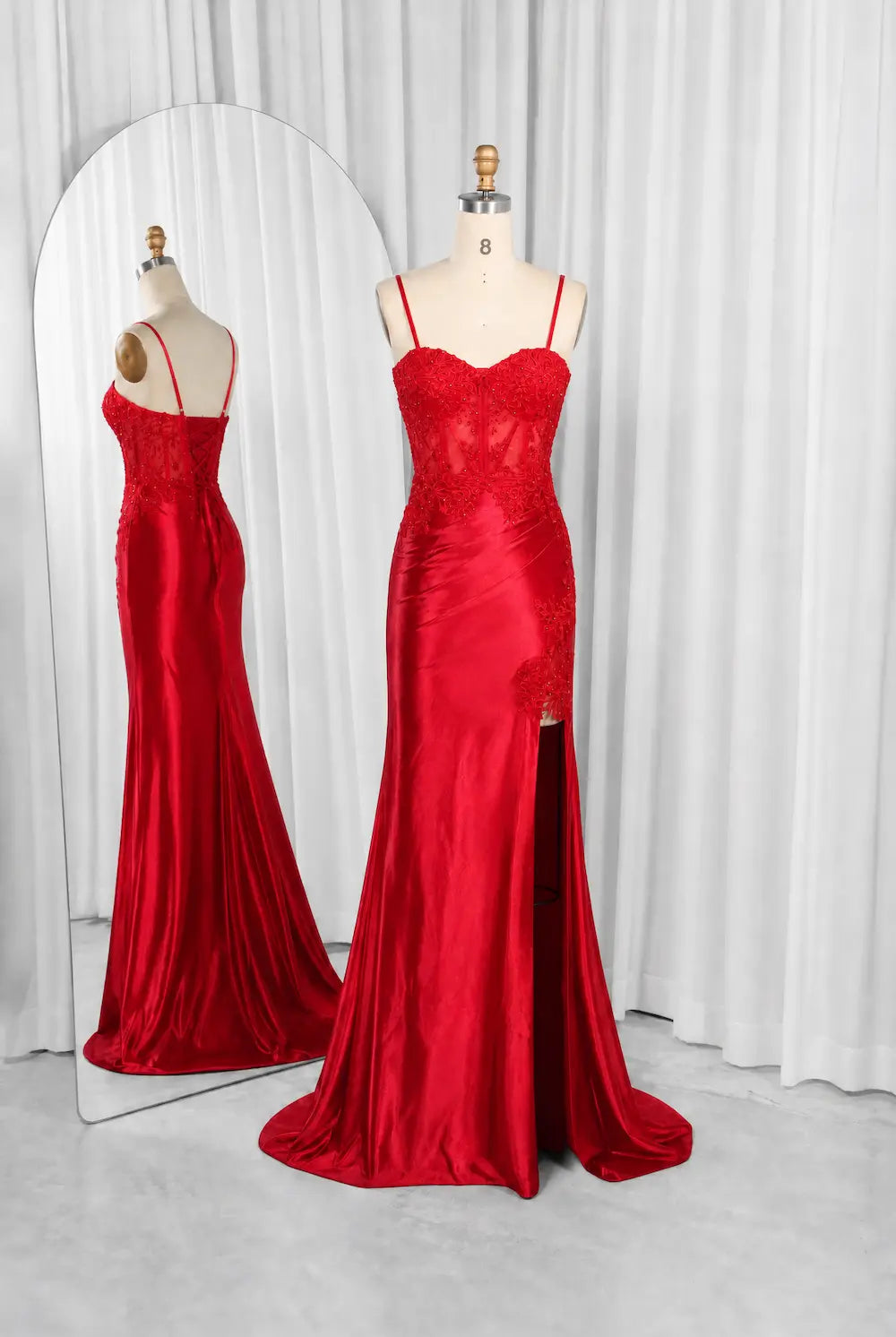 Red mermaid formal dress with lace bodice, spaghetti straps, and draped skirt