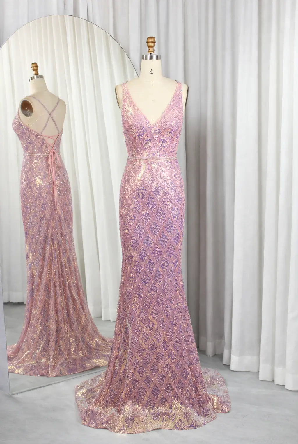 Iridescent pink sequin mermaid prom dress on mannequin with V-neck and spaghetti straps