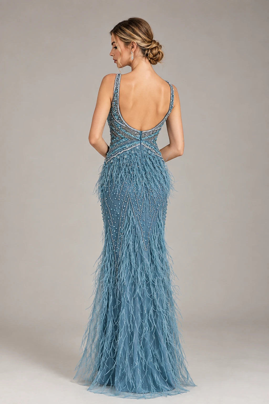 Dusty blue beaded prom dress with V-back, spaghetti straps, and feather fringe hem