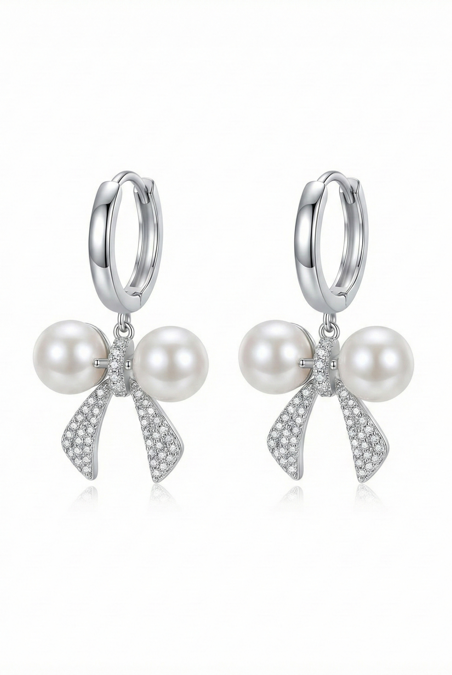 Silver-tone hoop earrings with two pearl drops and crystal bow knot