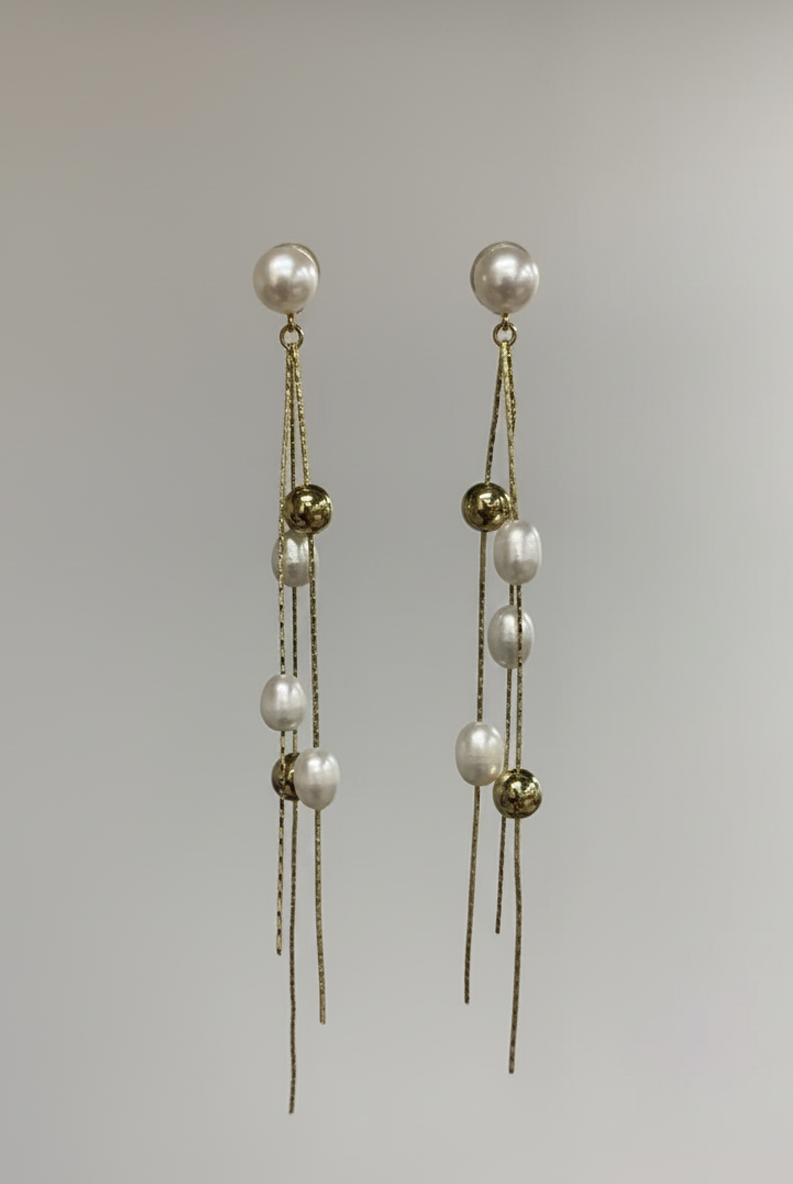 Long gold-tone chain tassel earrings with white pearl drops and gold beads