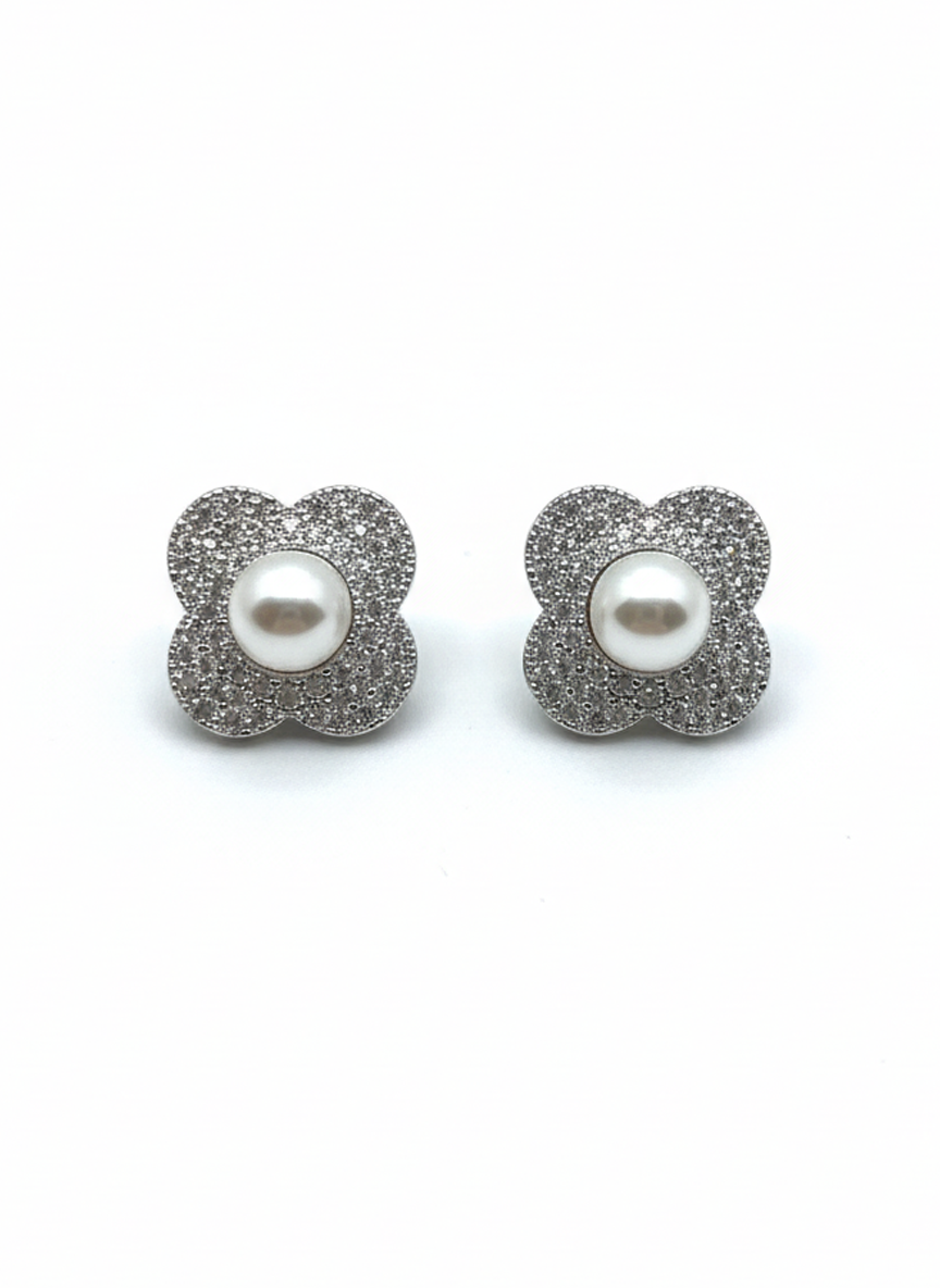 Floral stud earrings with glittery silver petals and a white pearl center