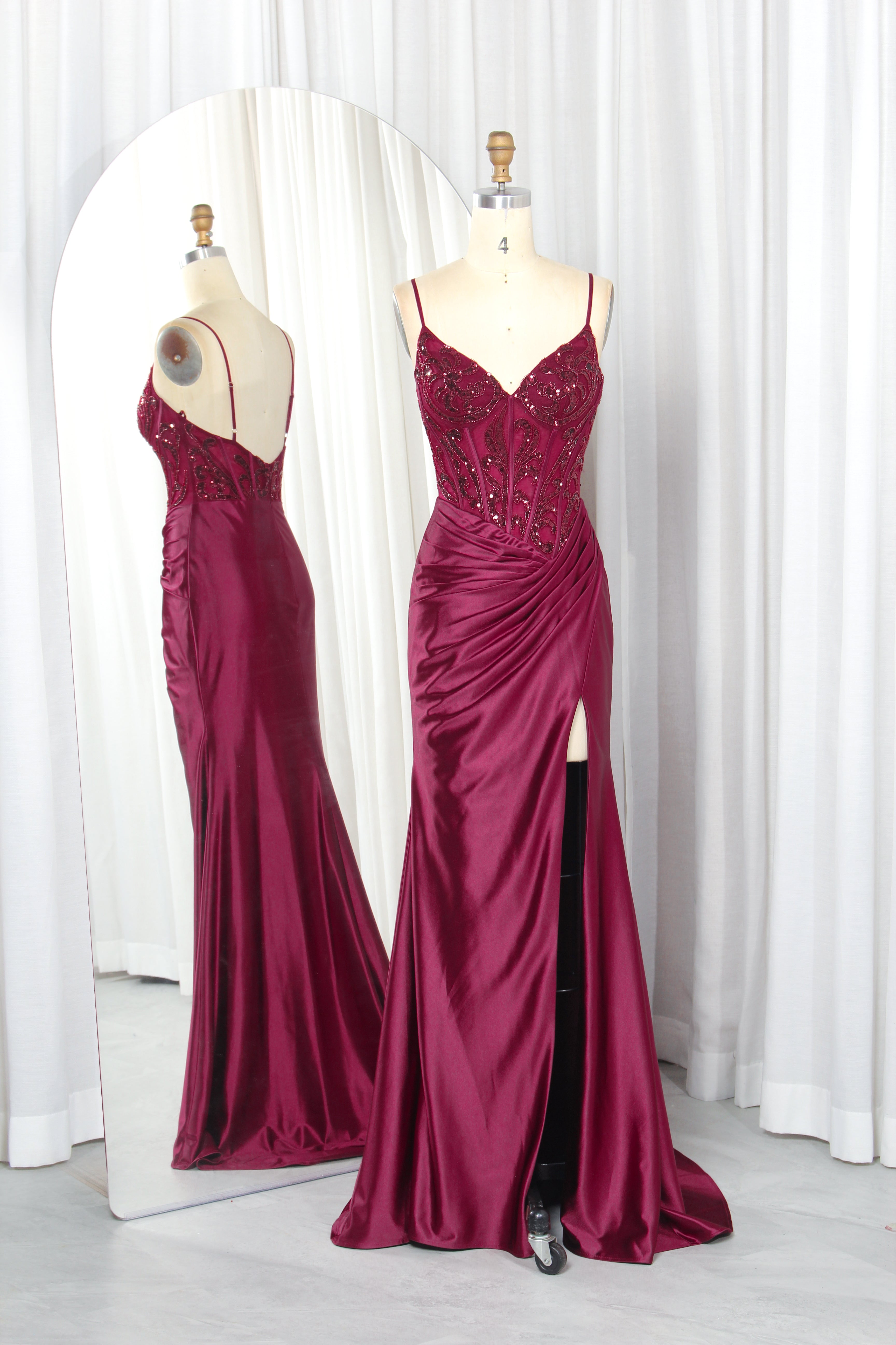 Burgundy satin mermaid gown with beaded corset bodice and front slit, two views