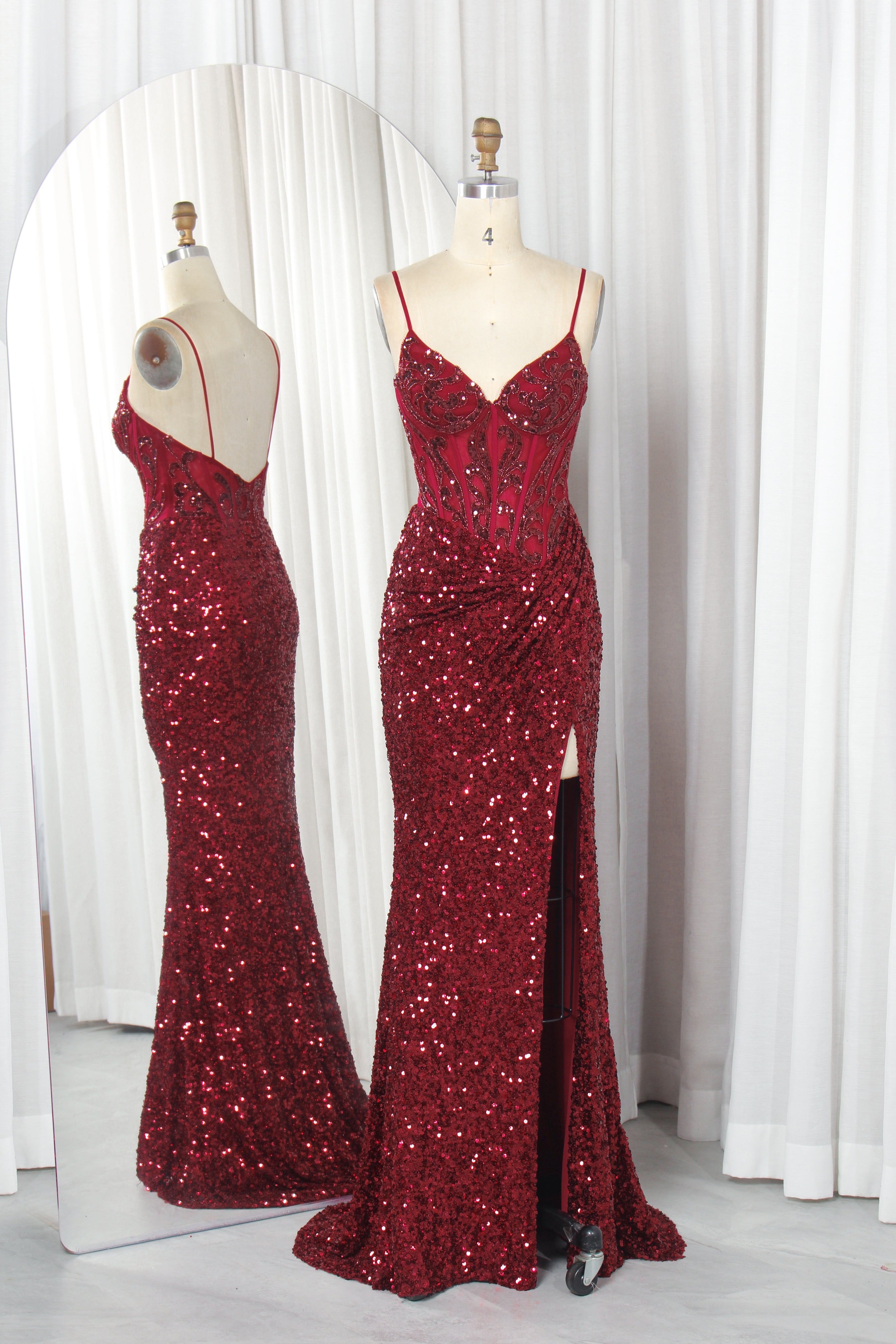 Wine red sequin corset slit gown on mannequins, thin straps, sweetheart neckline
