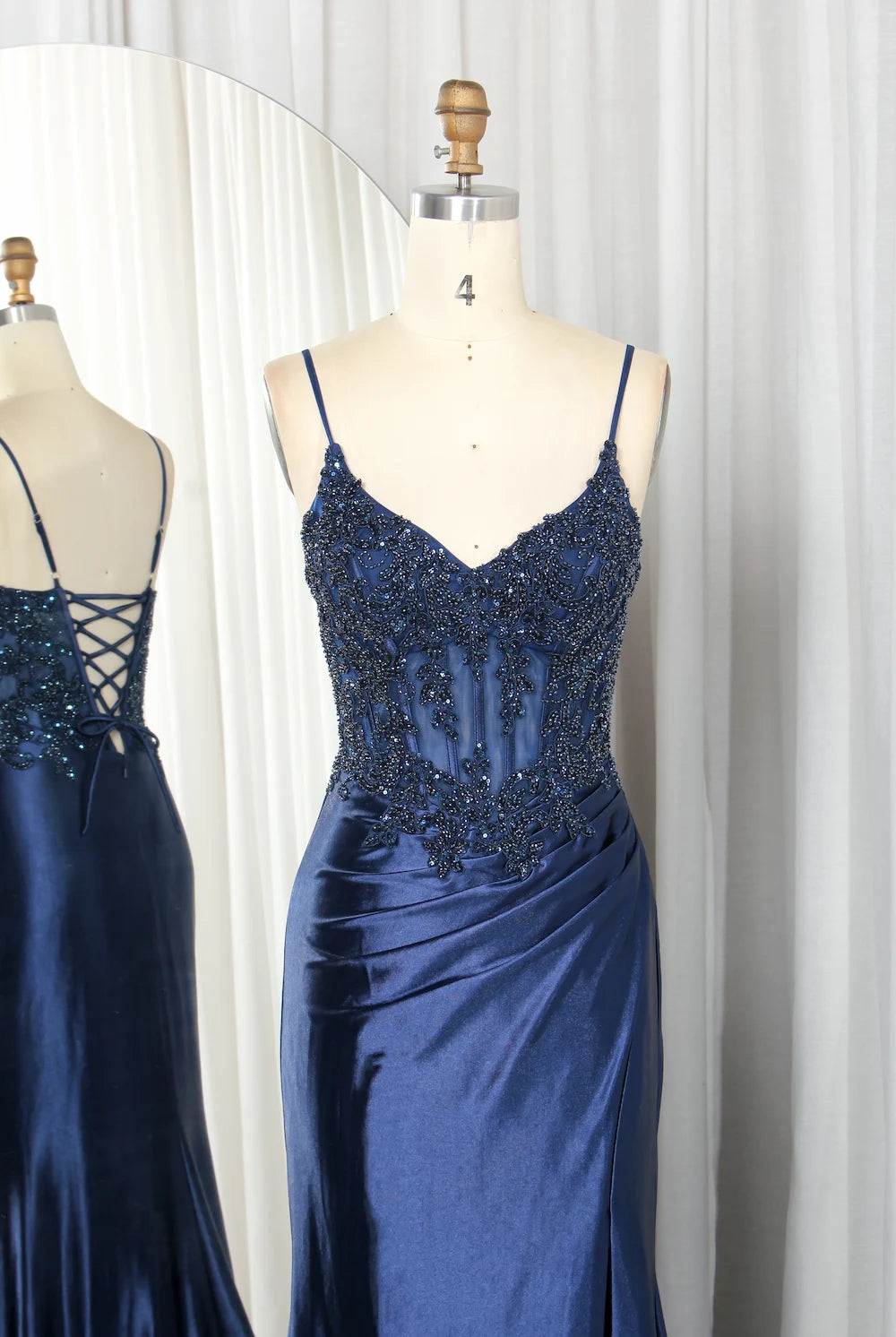 Navy beaded spaghetti-strap gown, satin corset waist on mannequin