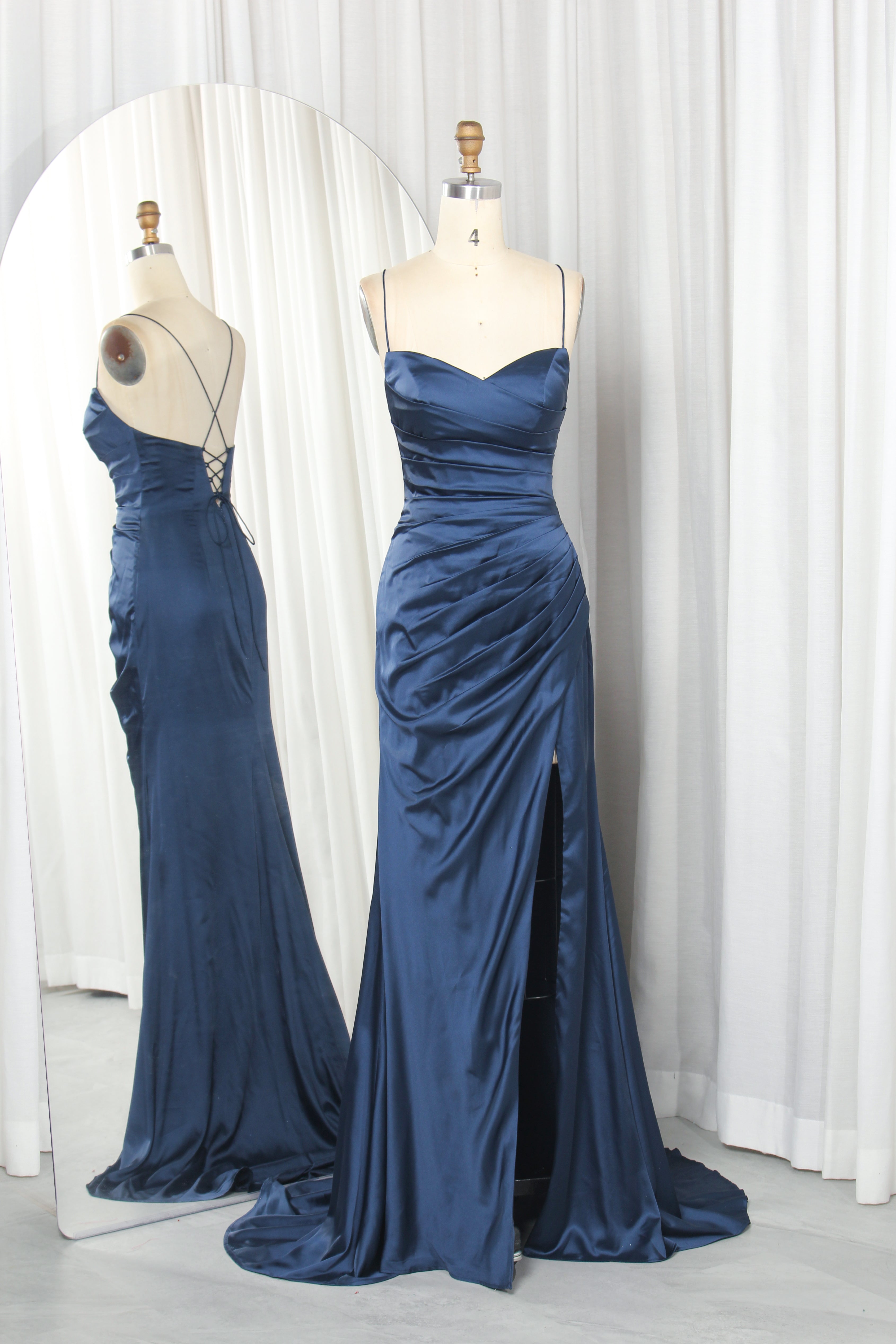 Navy satin sweetheart ruched gown with spaghetti straps and front slit