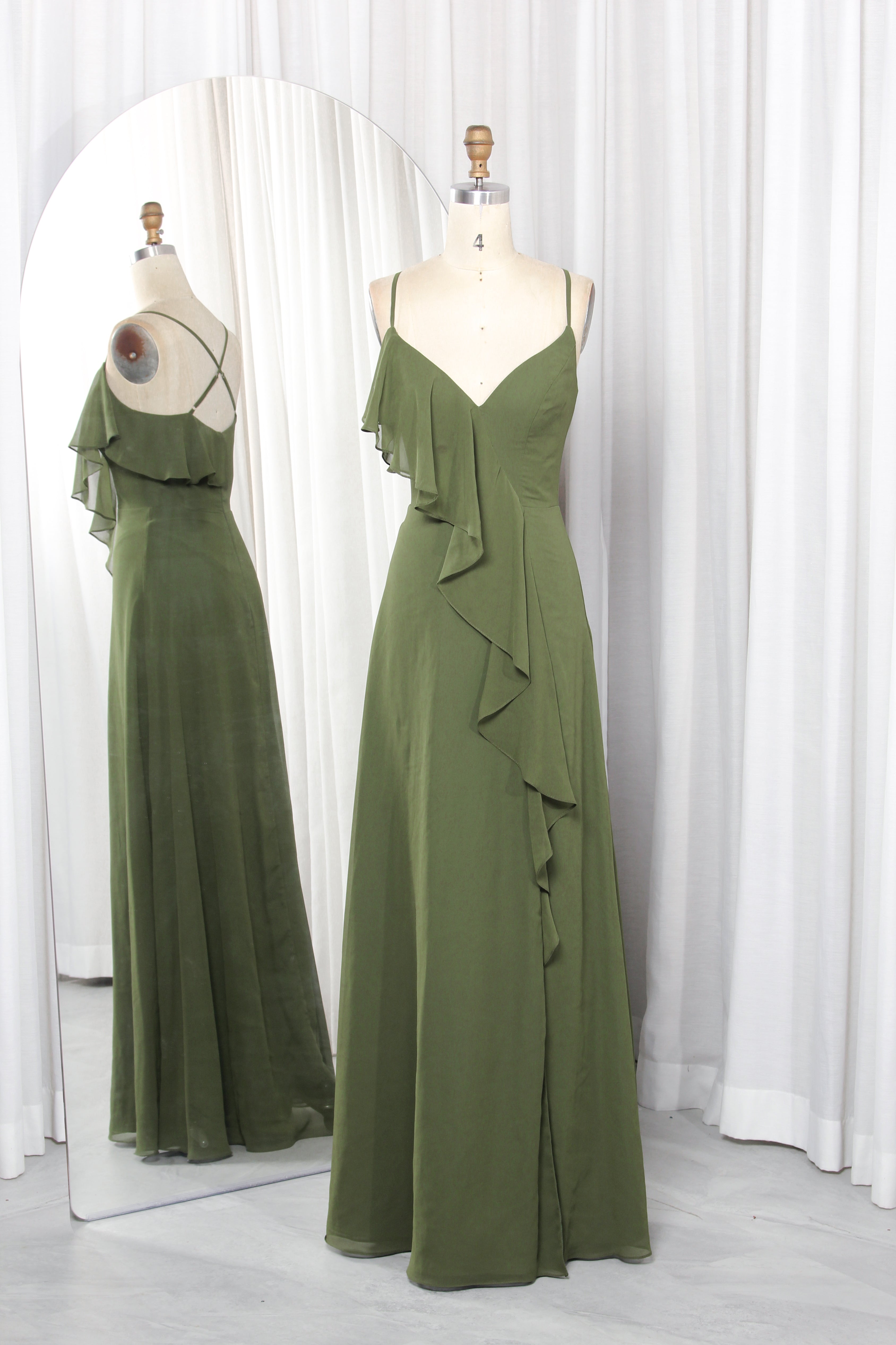 Olive green chiffon bridesmaid dress with spaghetti straps, V-neckline, and cascading ruffles on a mannequin