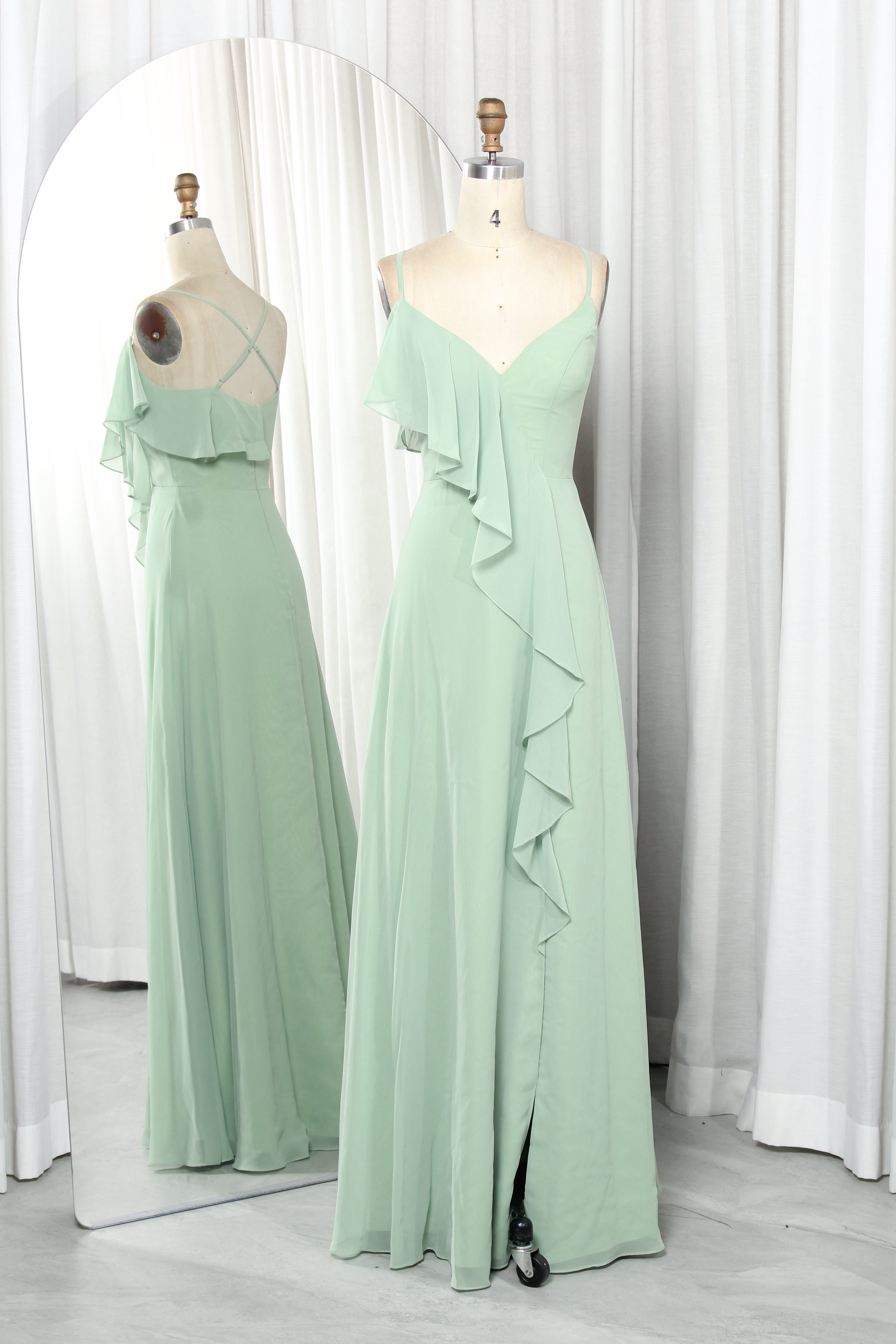 Olive green chiffon bridesmaid dress with spaghetti straps, V-neckline, and cascading ruffles on a mannequin