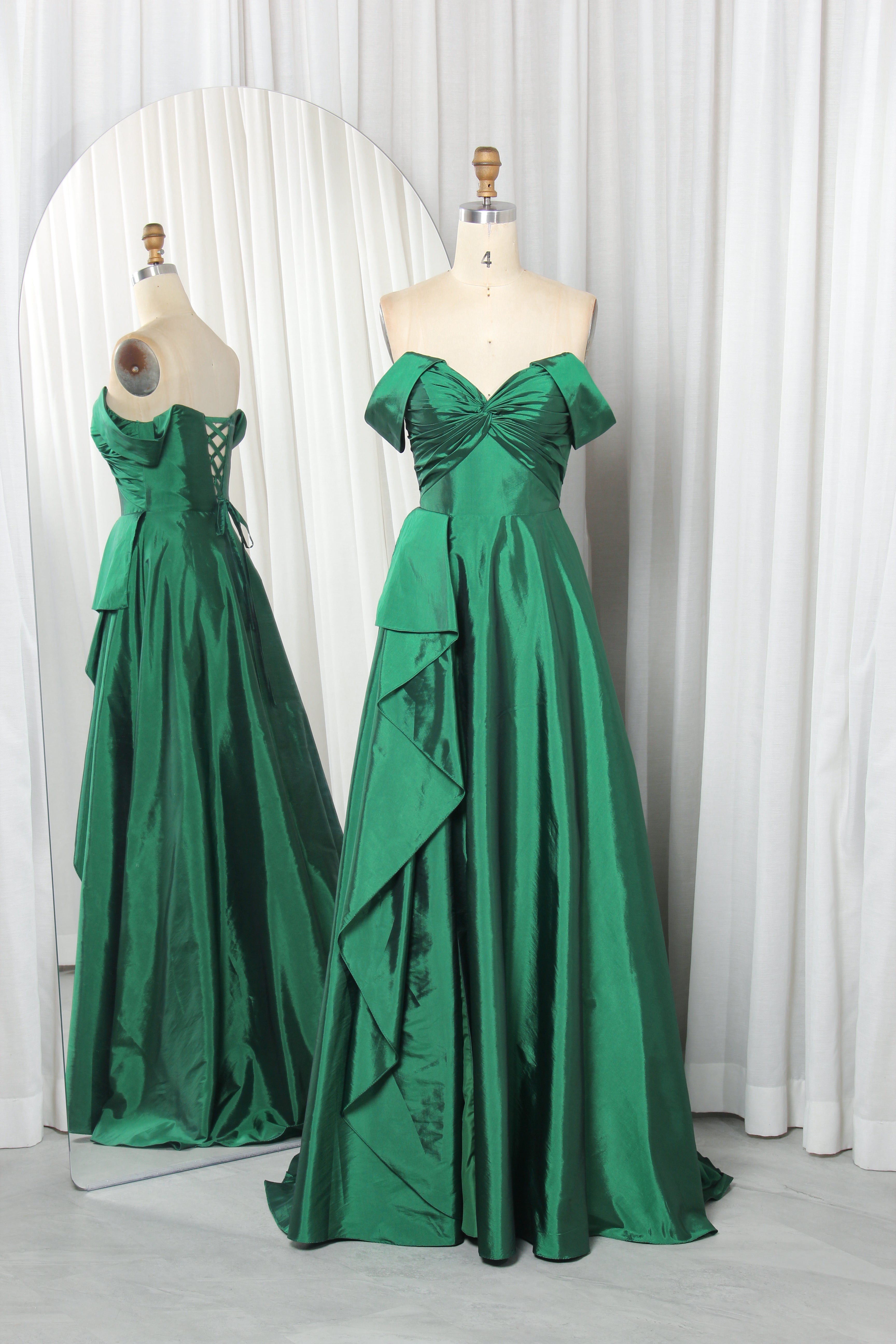 Emerald off-shoulder A-line prom gown with bow bodice and draped skirt