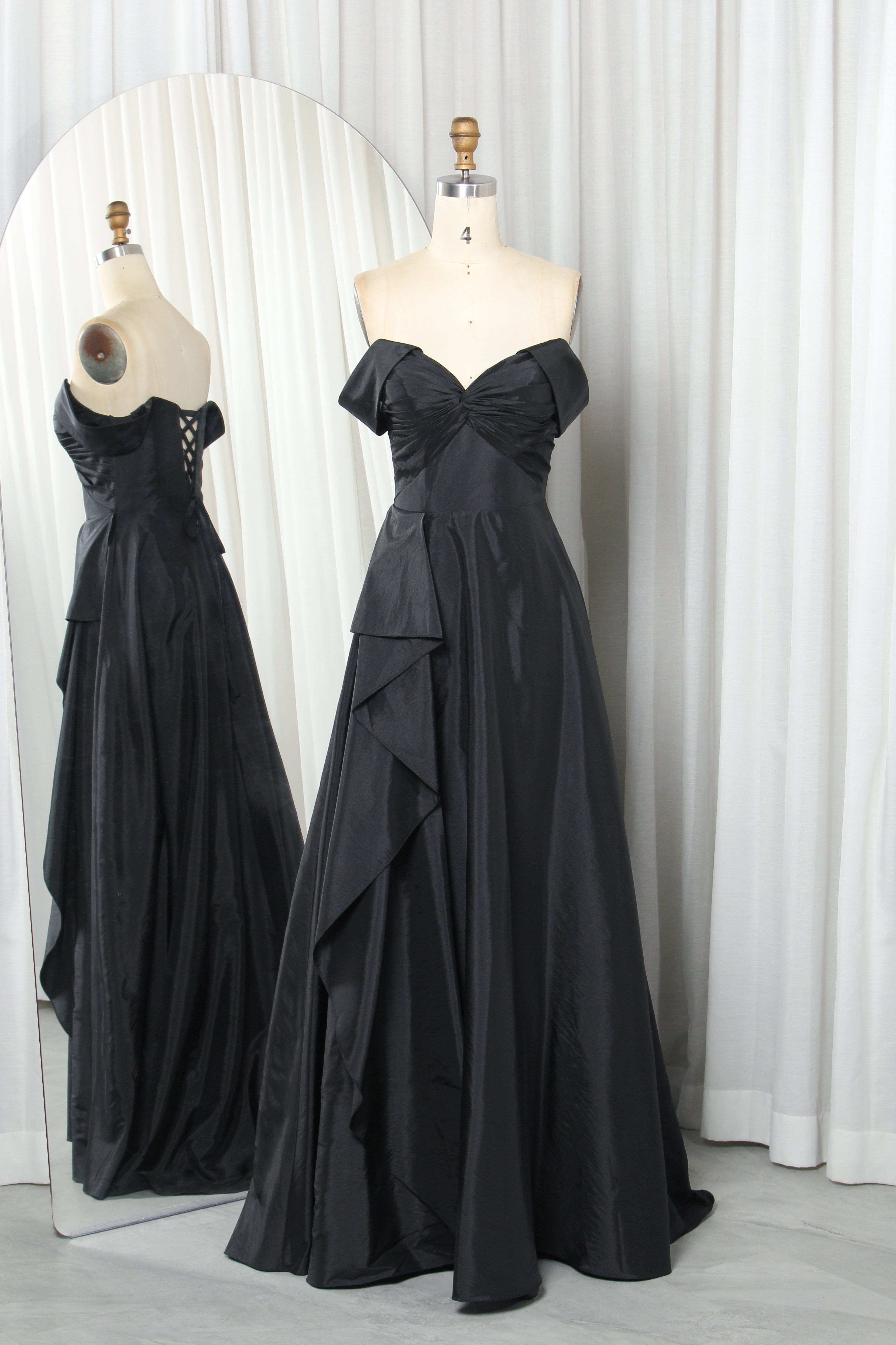 Black off-shoulder A-line prom gown with bow bodice and crisscross lace-up back