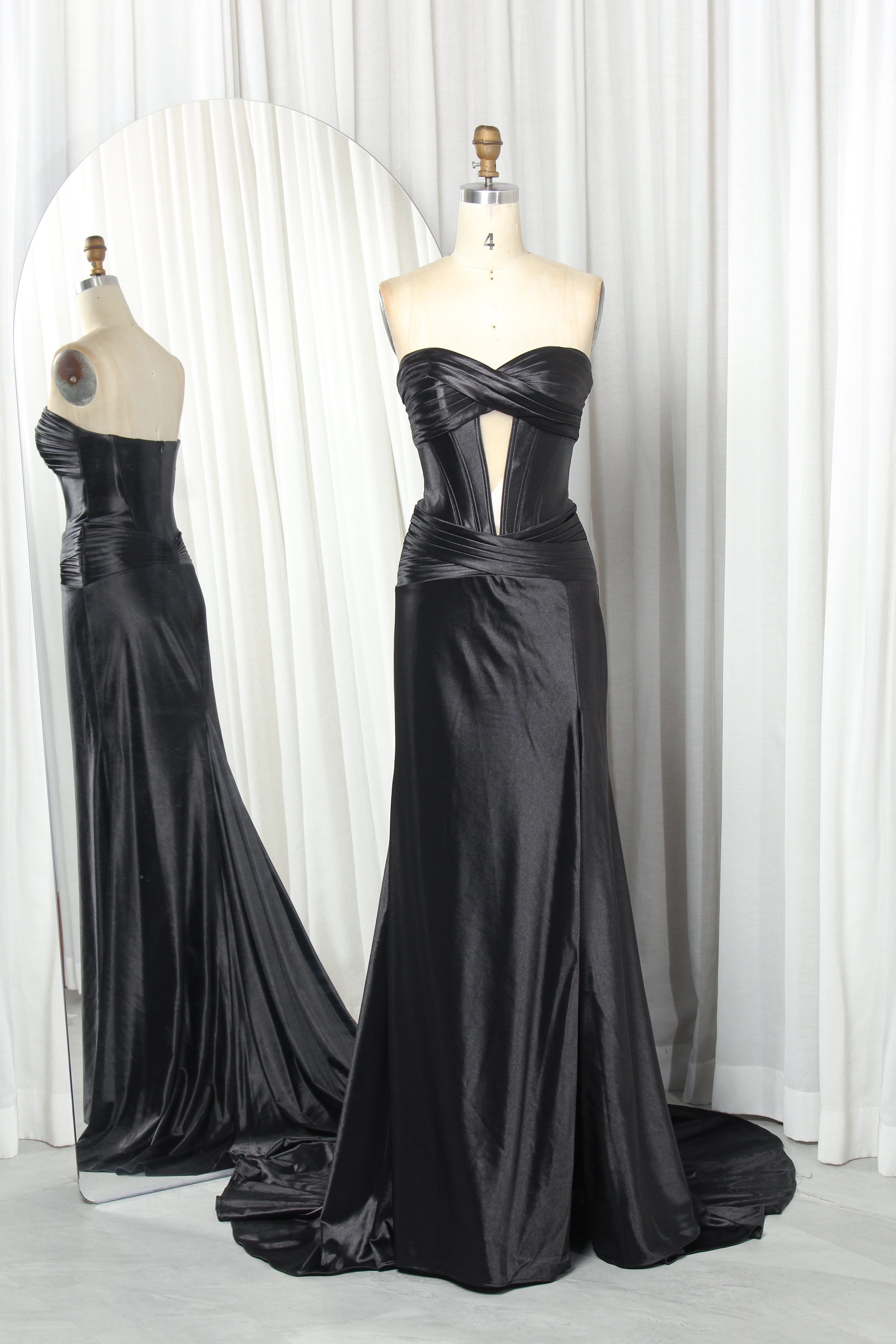 Black satin strapless corset mermaid gown on mannequin with crisscross corset bodice