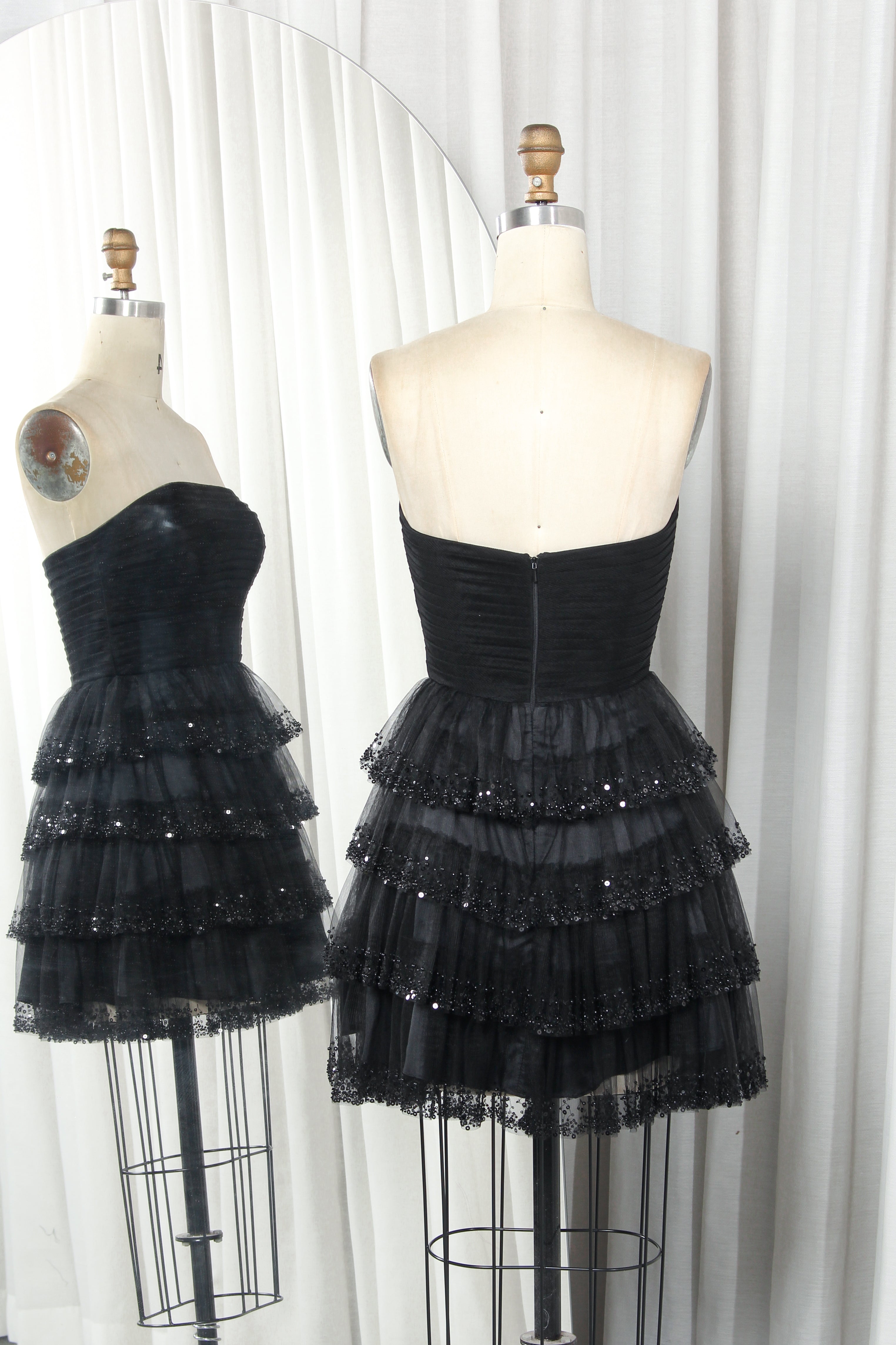 Black strapless sweetheart tiered tulle dress with layered ruffles and sequin trim