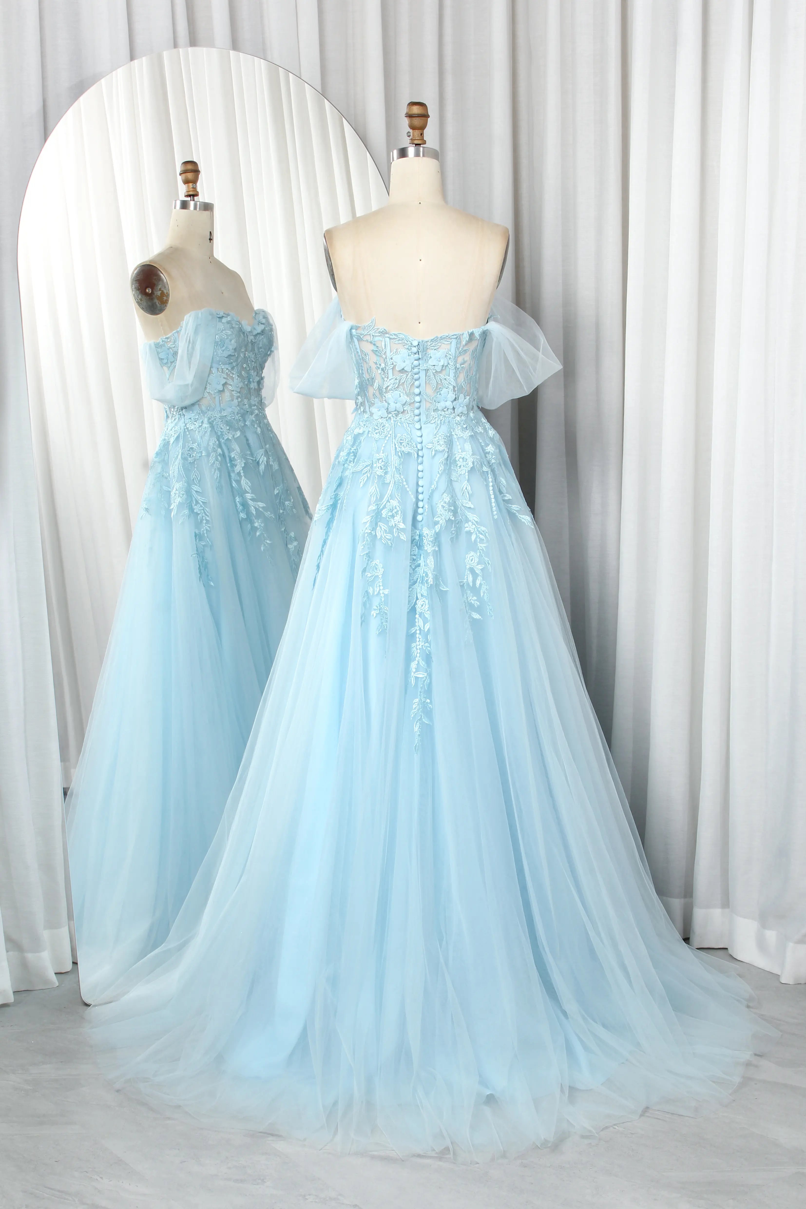 Light blue off-the-shoulder A-line prom dress on mannequins, lace bodice and tulle skirt