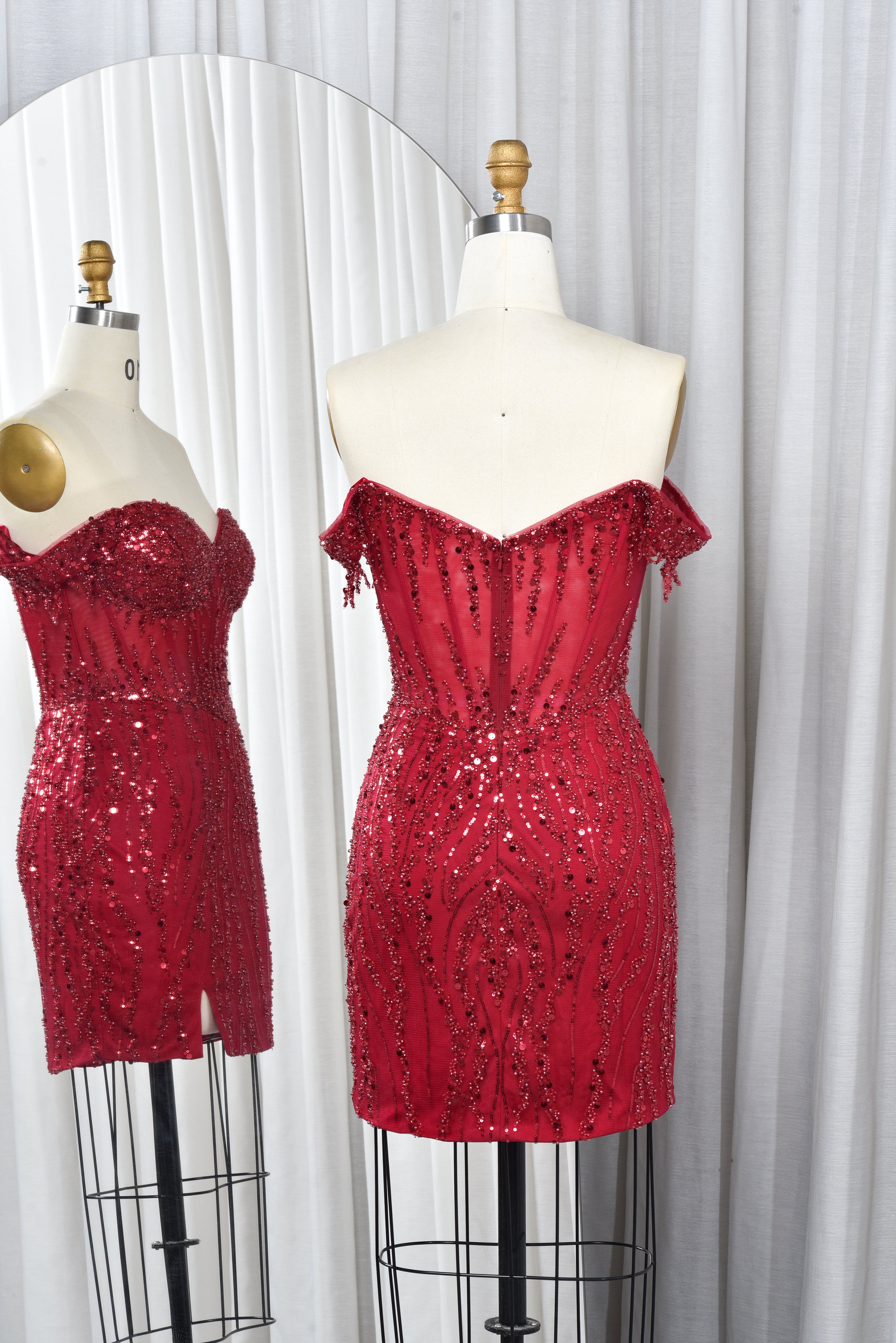 Wine red off-shoulder sequin corset mini dress on mannequin, open corset back detail