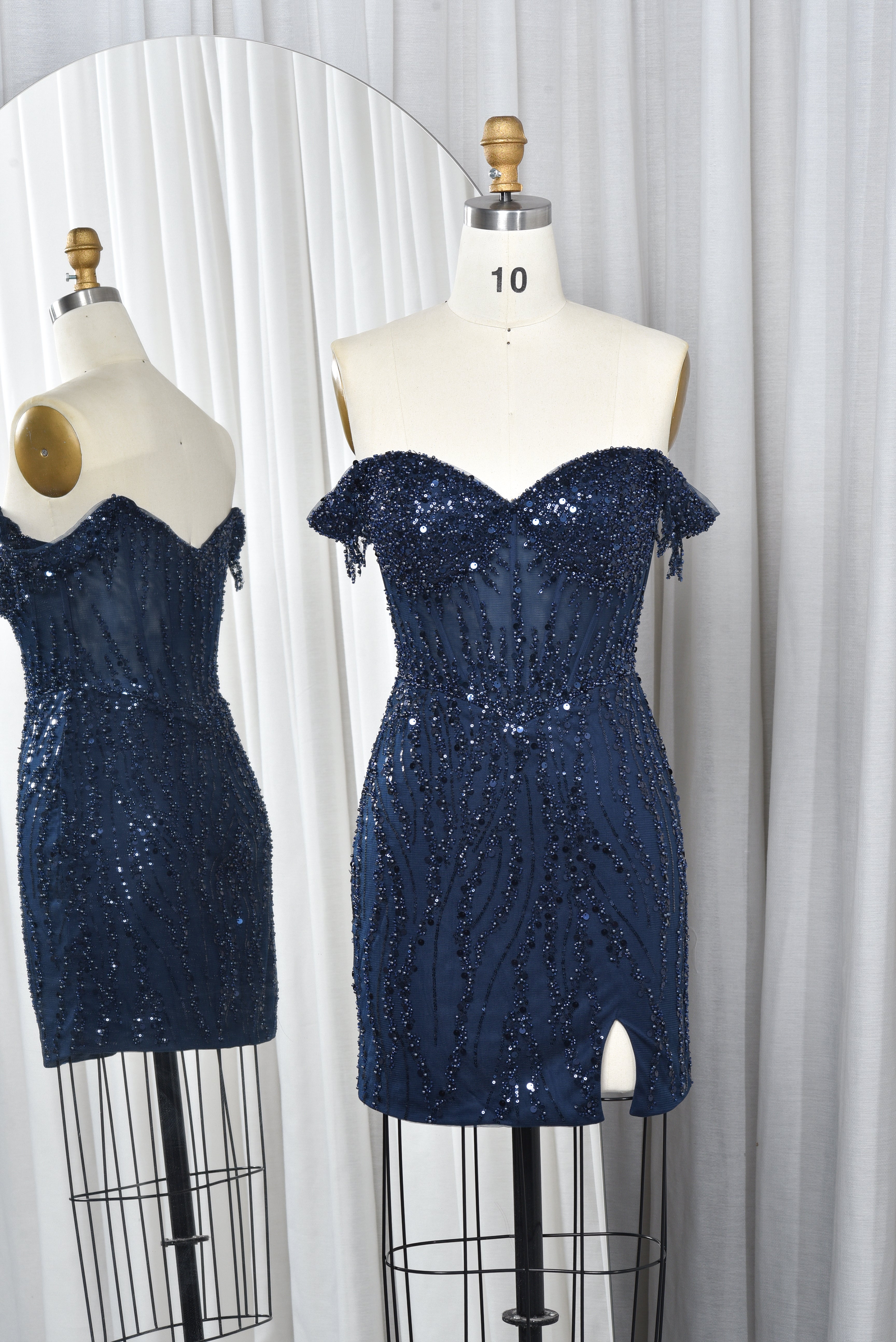 Navy off-shoulder sequin corset mini dress with side slit on mannequin