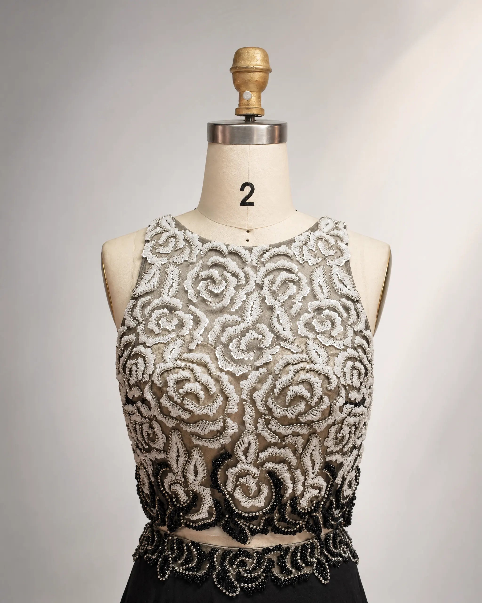 Embroidered chiffon mother-of-the-bride dress bodice with ornate swirls and beaded belt