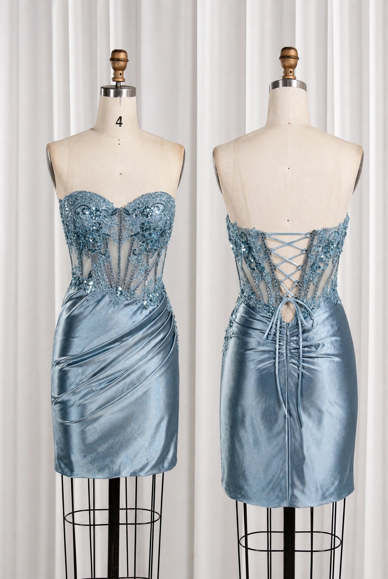 Dusty blue strapless homecoming dress on mannequins, lace corset front and lace-up back